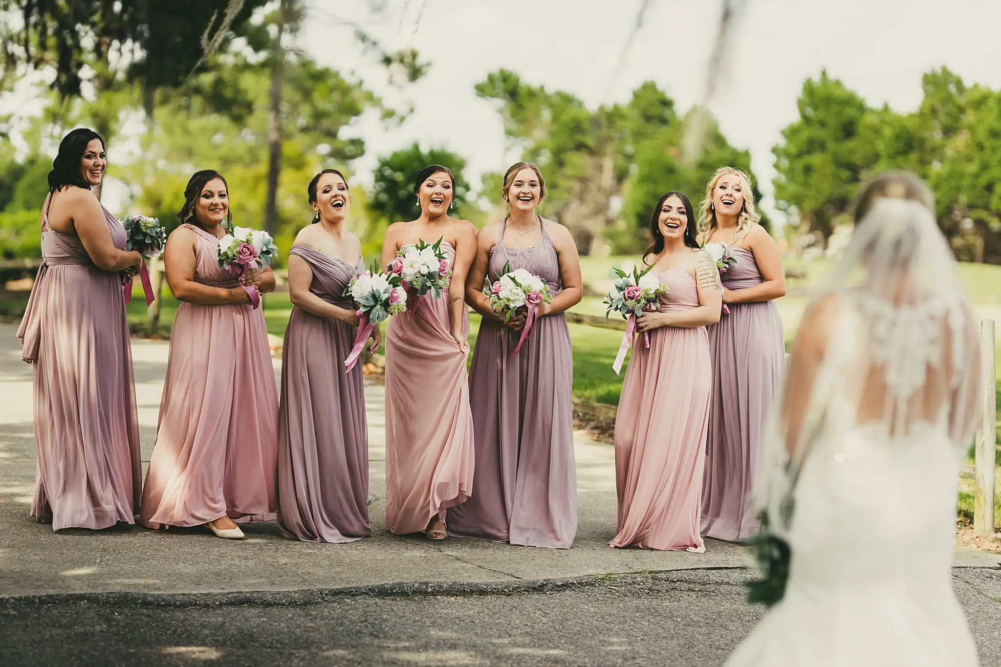Wedding Party: the bridesmaids in dusty rose on the cart path, at their wedding at Houston Lake Country Club in Perry, GA