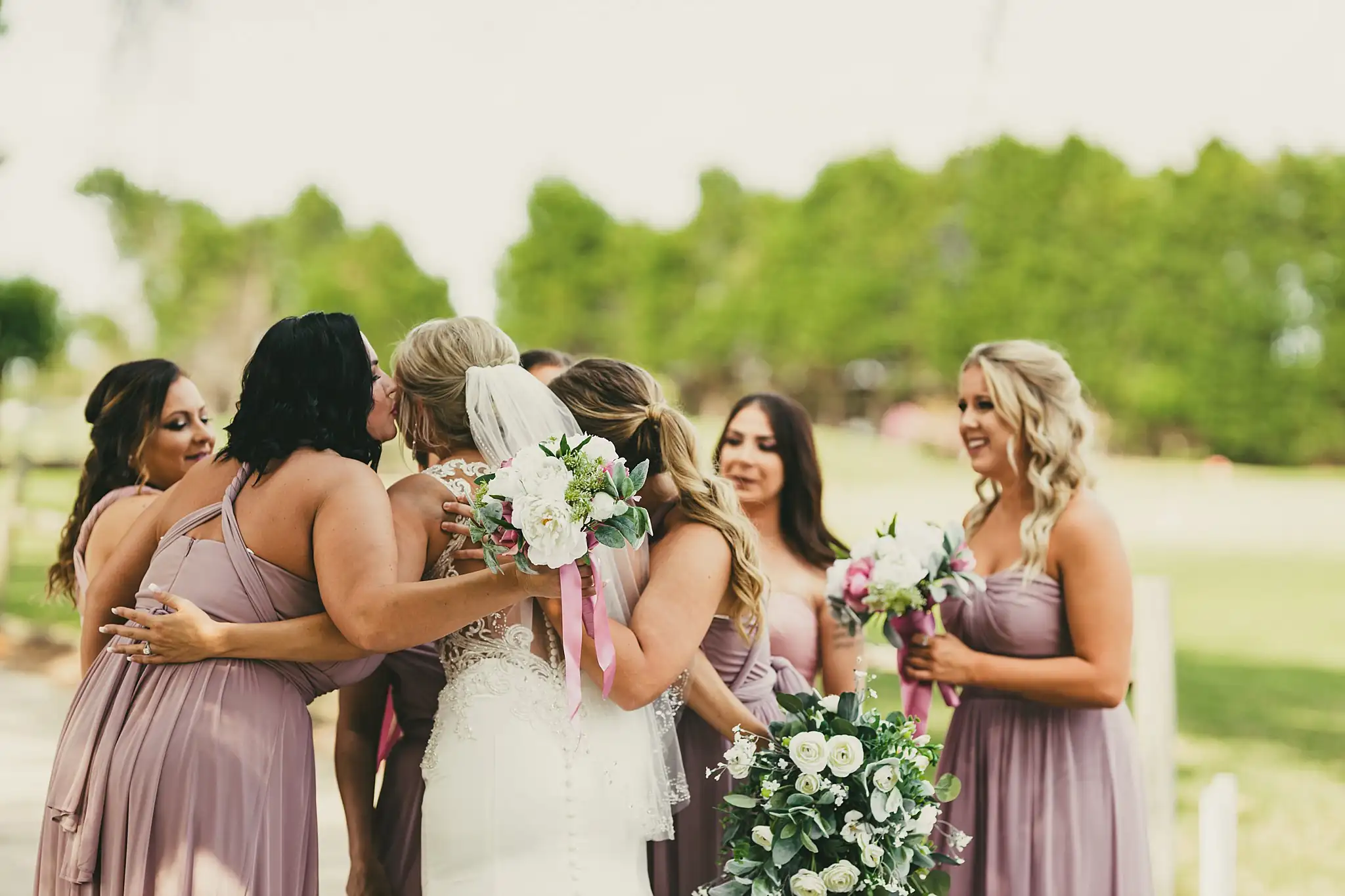 Wedding Party: the bridesmaids gathered around the bride, at their wedding at Houston Lake Country Club in Perry, GA