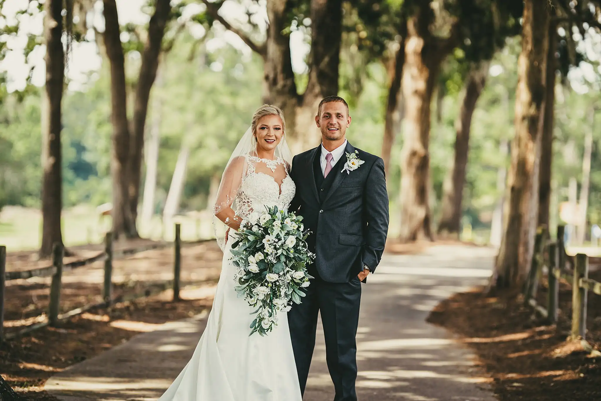 Wedding Formals: the couple on the moss-draped path, at their wedding at Houston Lake Country Club in Perry, GA