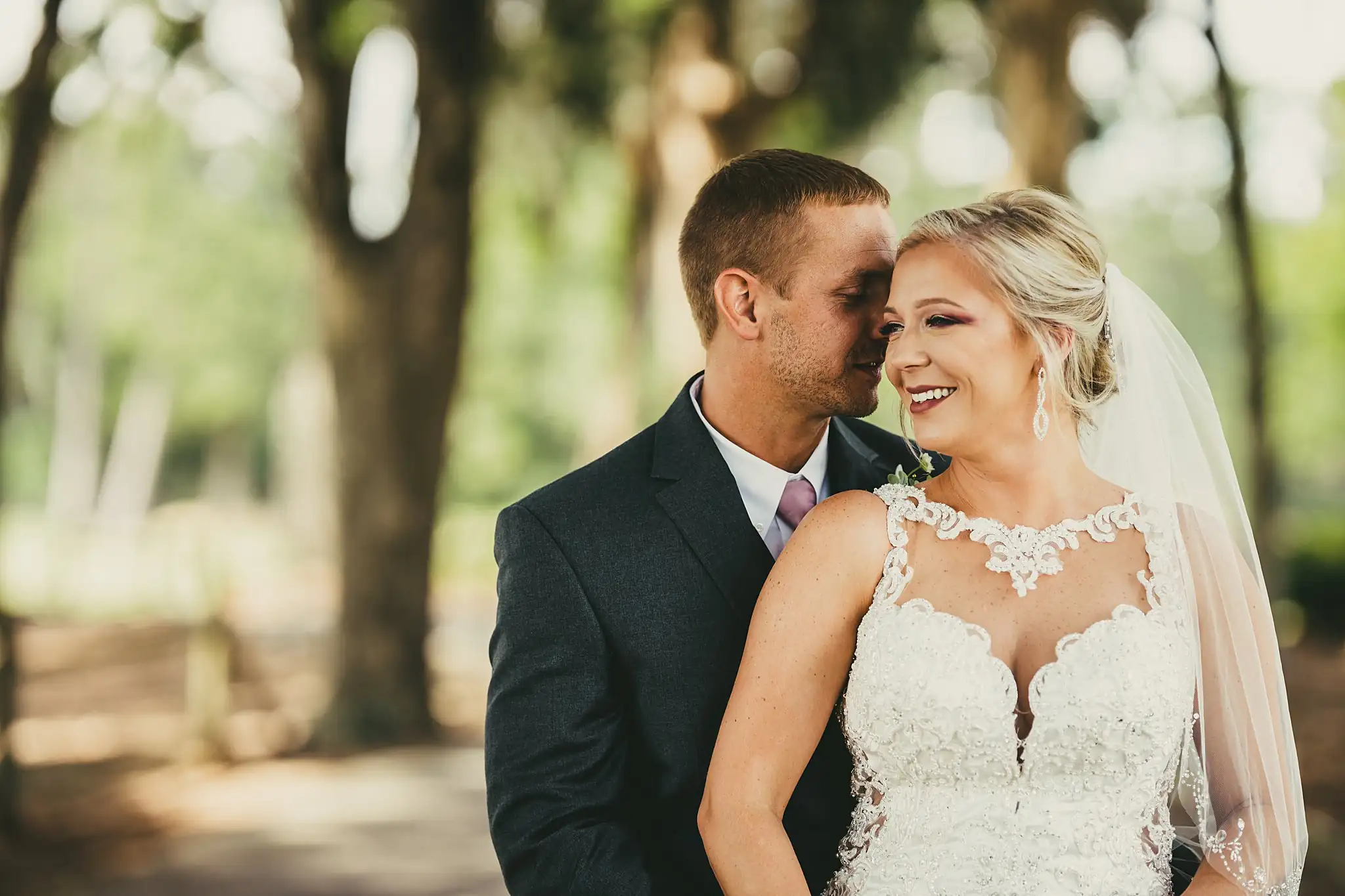 Wedding Formals: the couple with their foreheads together, at their wedding at Houston Lake Country Club in Perry, GA