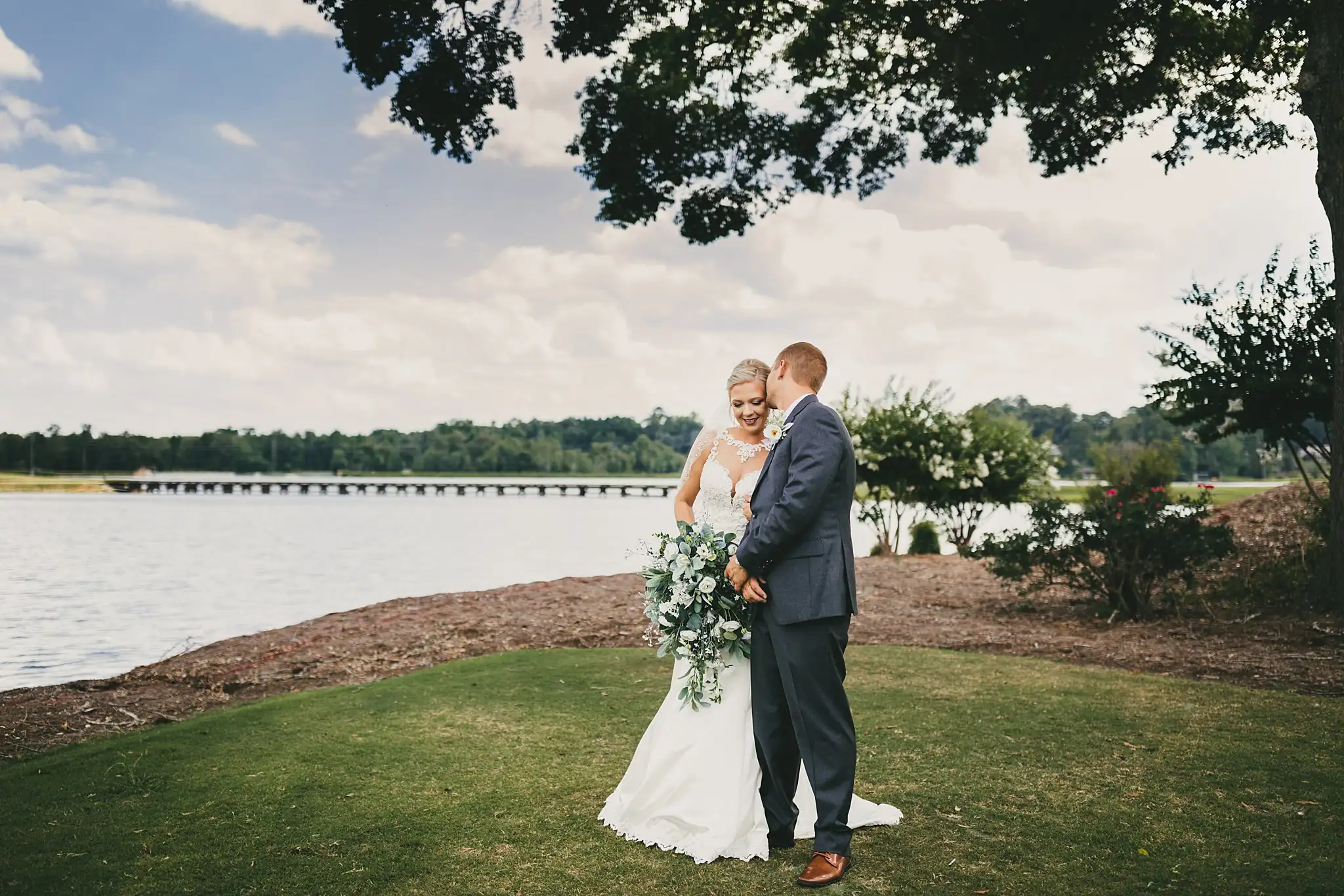 Wedding Formals: the couple on the lawn above the lake, at their wedding at Houston Lake Country Club in Perry, GA