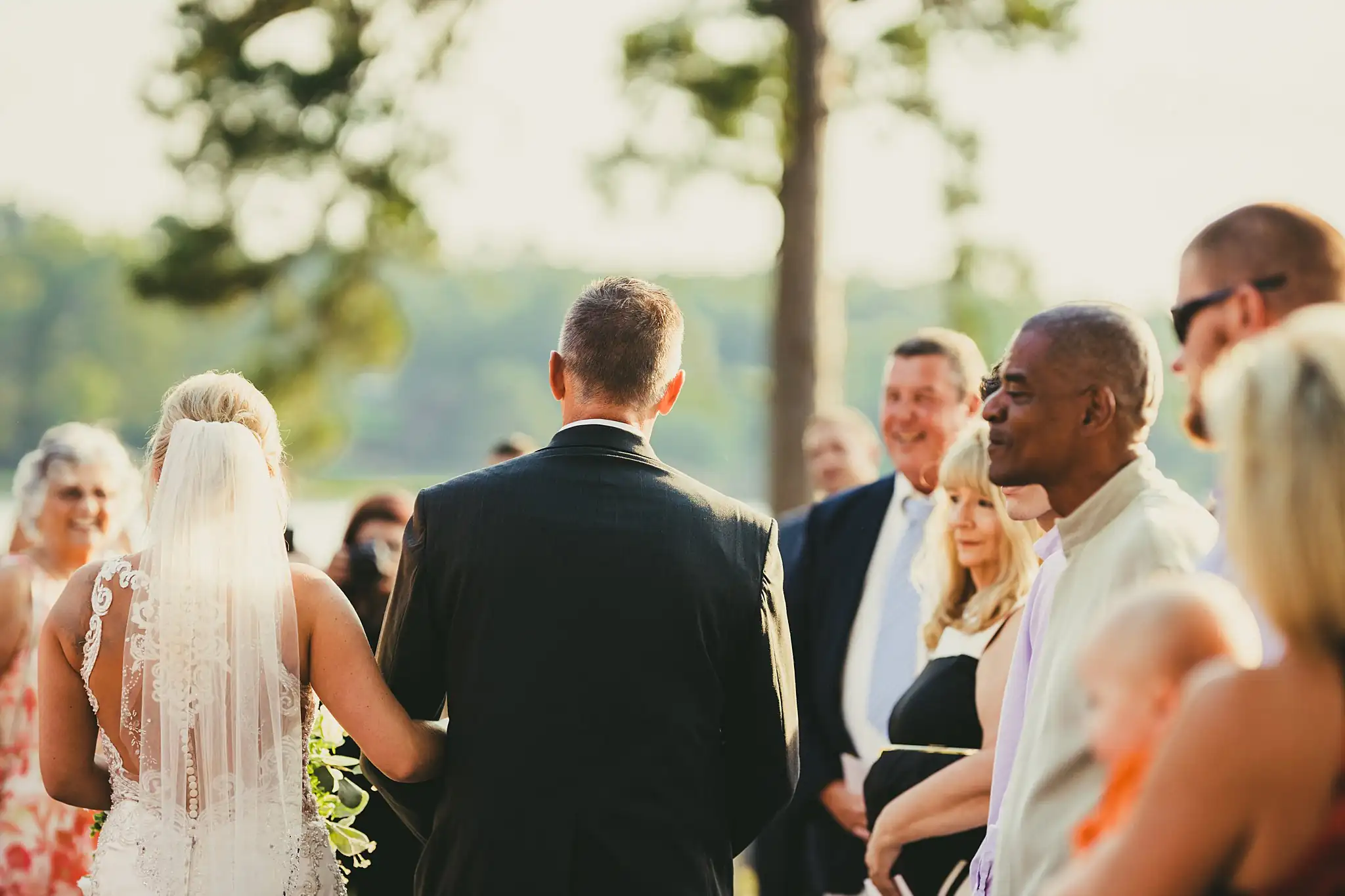 Processional: the bride and her father from behind, at their wedding at Houston Lake Country Club in Perry, GA