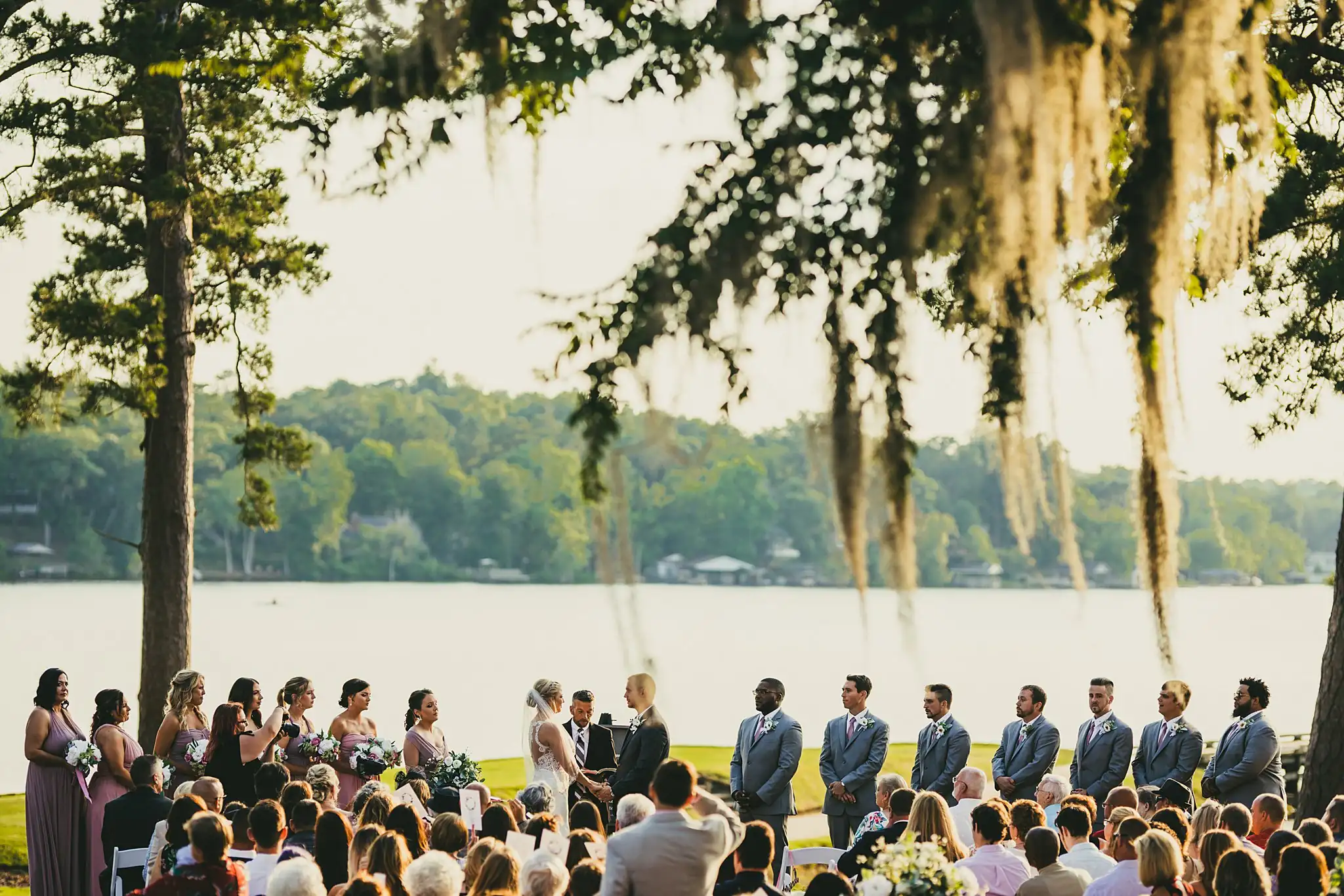 Wedding Ceremony: the ceremony seen from the side, at their wedding at Houston Lake Country Club in Perry, GA