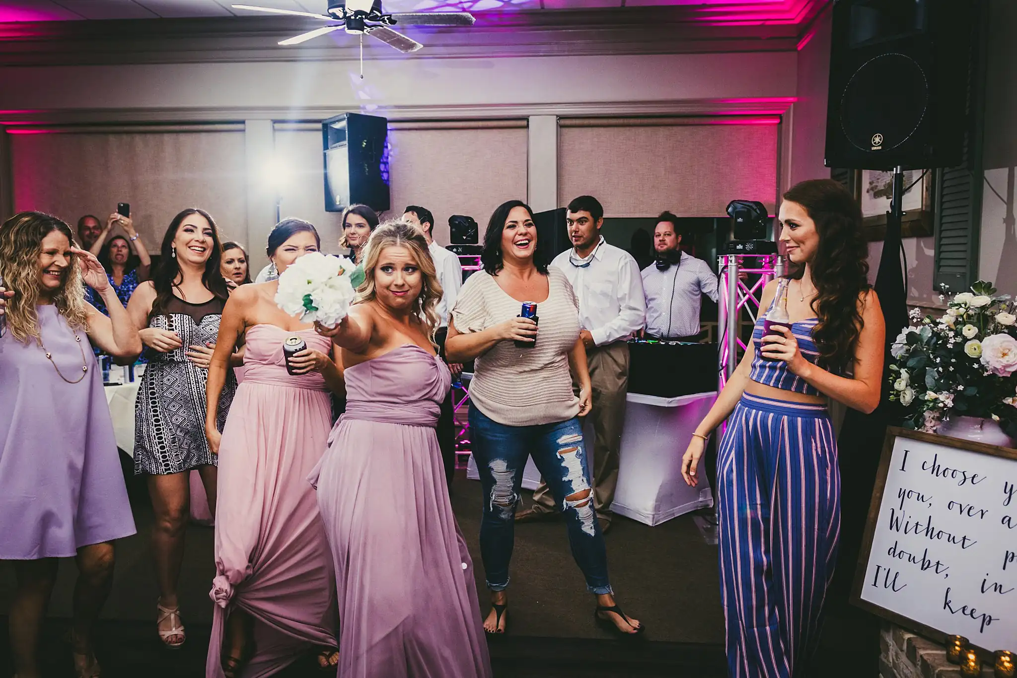 Bouquet Toss: the catch, the bridesmaids reacting, at their wedding at Houston Lake Country Club in Perry, GA