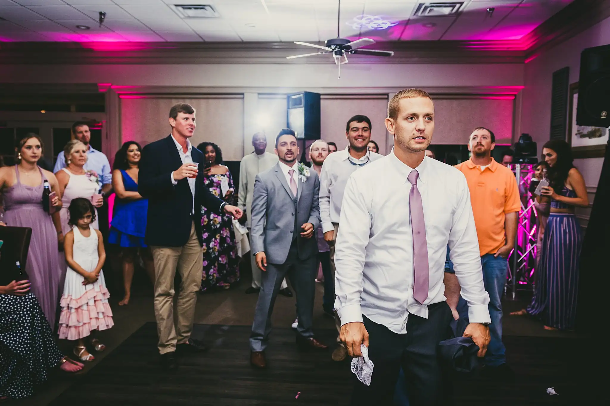 Garter Toss: the men lined up for the garter, at their wedding at Houston Lake Country Club in Perry, GA