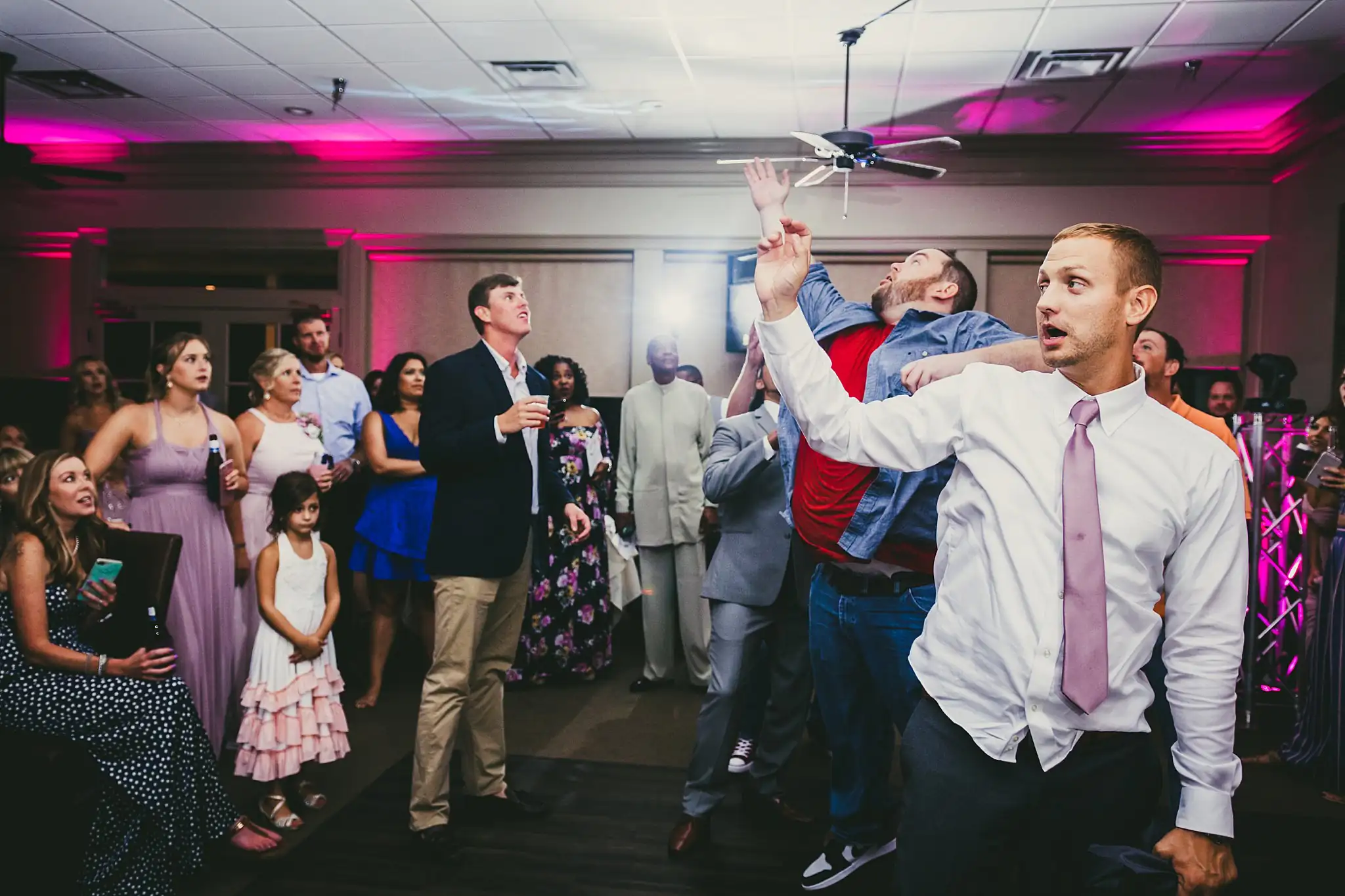 Garter Toss: the groom throwing the garter, at their wedding at Houston Lake Country Club in Perry, GA