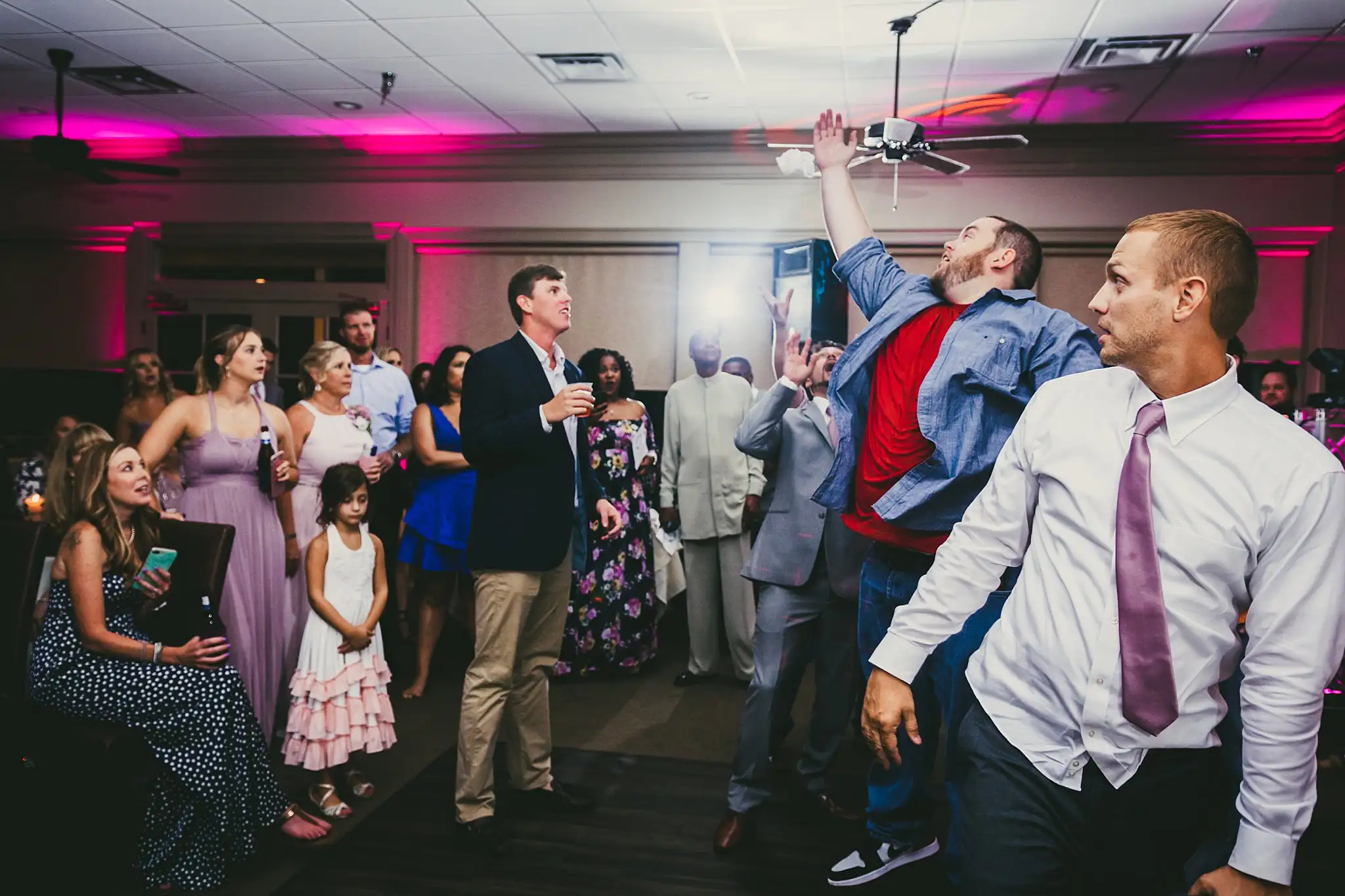 Garter Toss: the men reaching for the garter, at their wedding at Houston Lake Country Club in Perry, GA