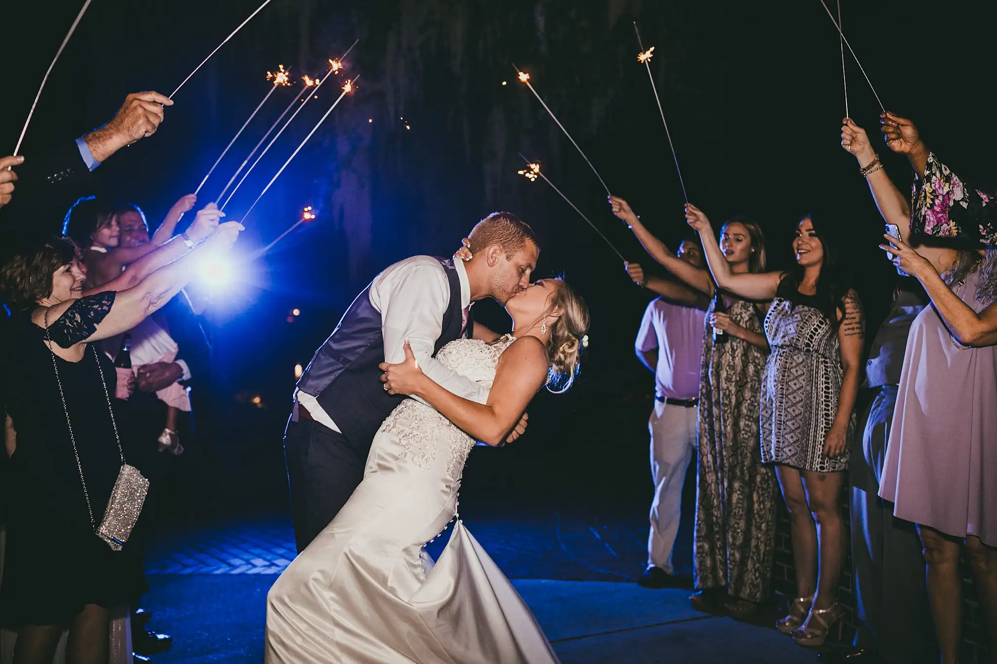 Sparkler Exit: the groom dipping the bride amid the sparklers, at their wedding at Houston Lake Country Club in Perry, GA