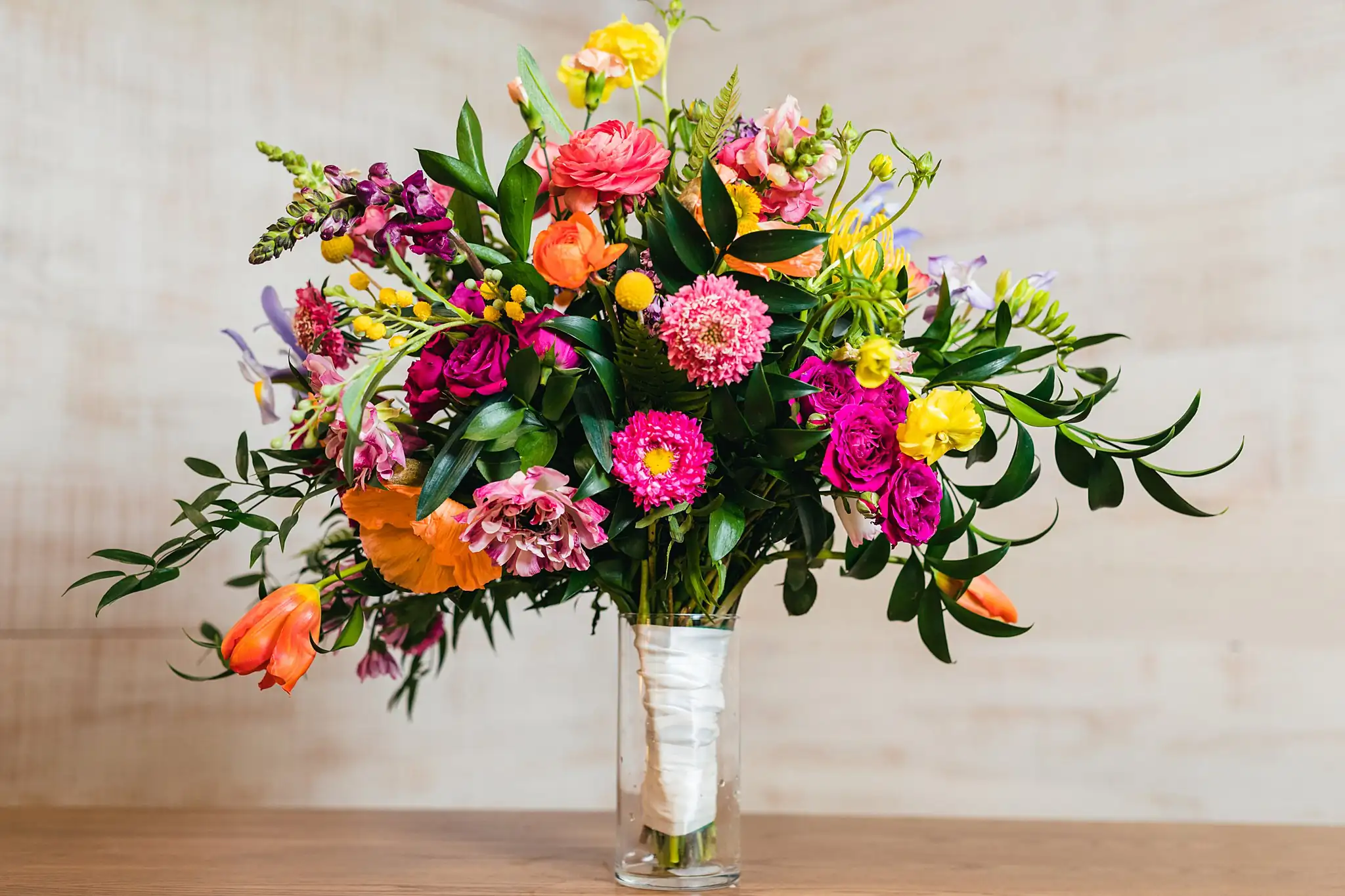 AtlantaWeddingPhotographers_1222.jpg Wedding Florals: a tall bright arrangement in a glass vase, at a Whimsically in Love LGBTQ Wedding styled shoot at Brick and Ivey in Marietta, GA