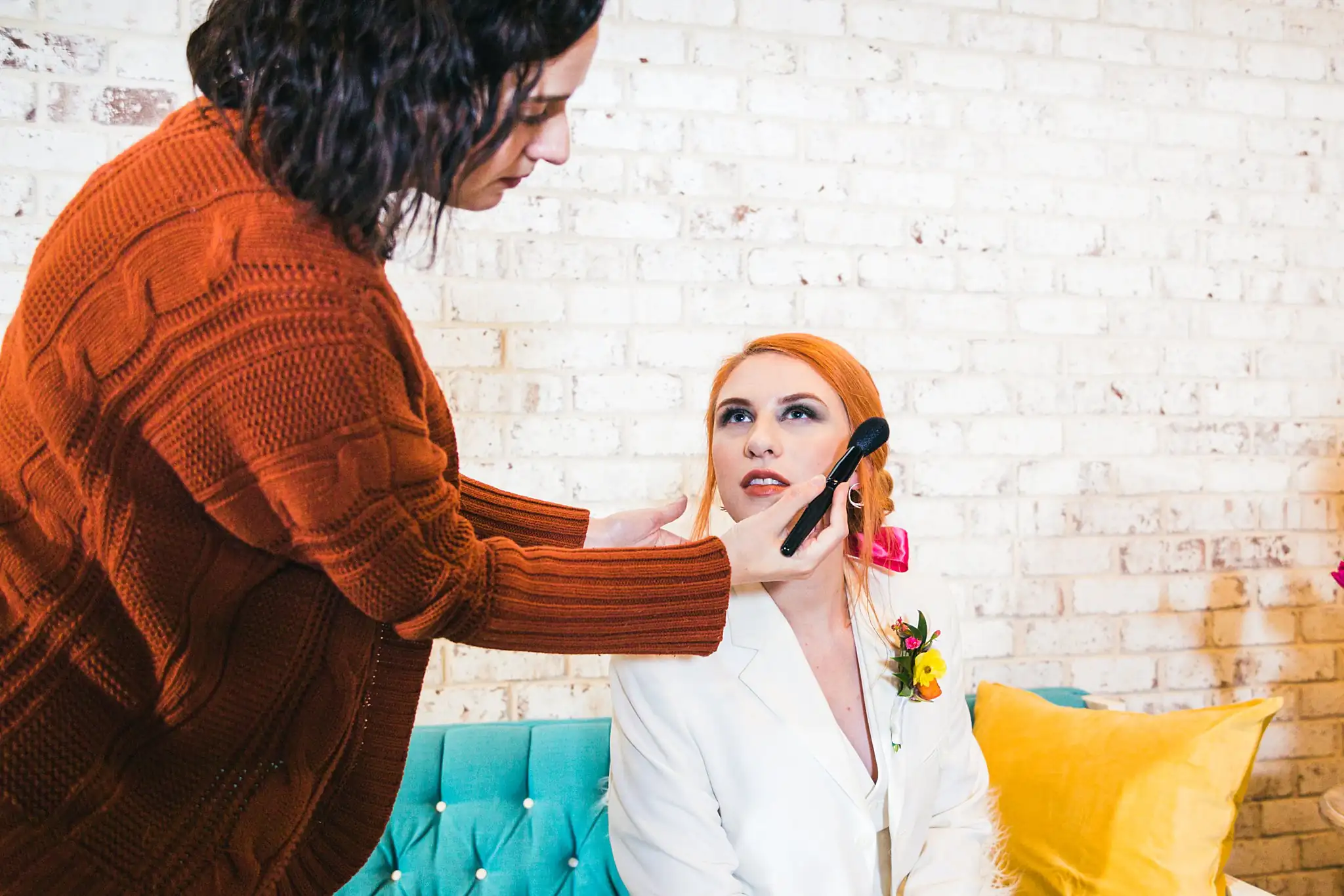 AtlantaWeddingPhotographers_1223.jpg Getting Ready: makeup being done on the bride in the suit, at a Whimsically in Love LGBTQ Wedding styled shoot at Brick and Ivey in Marietta, GA