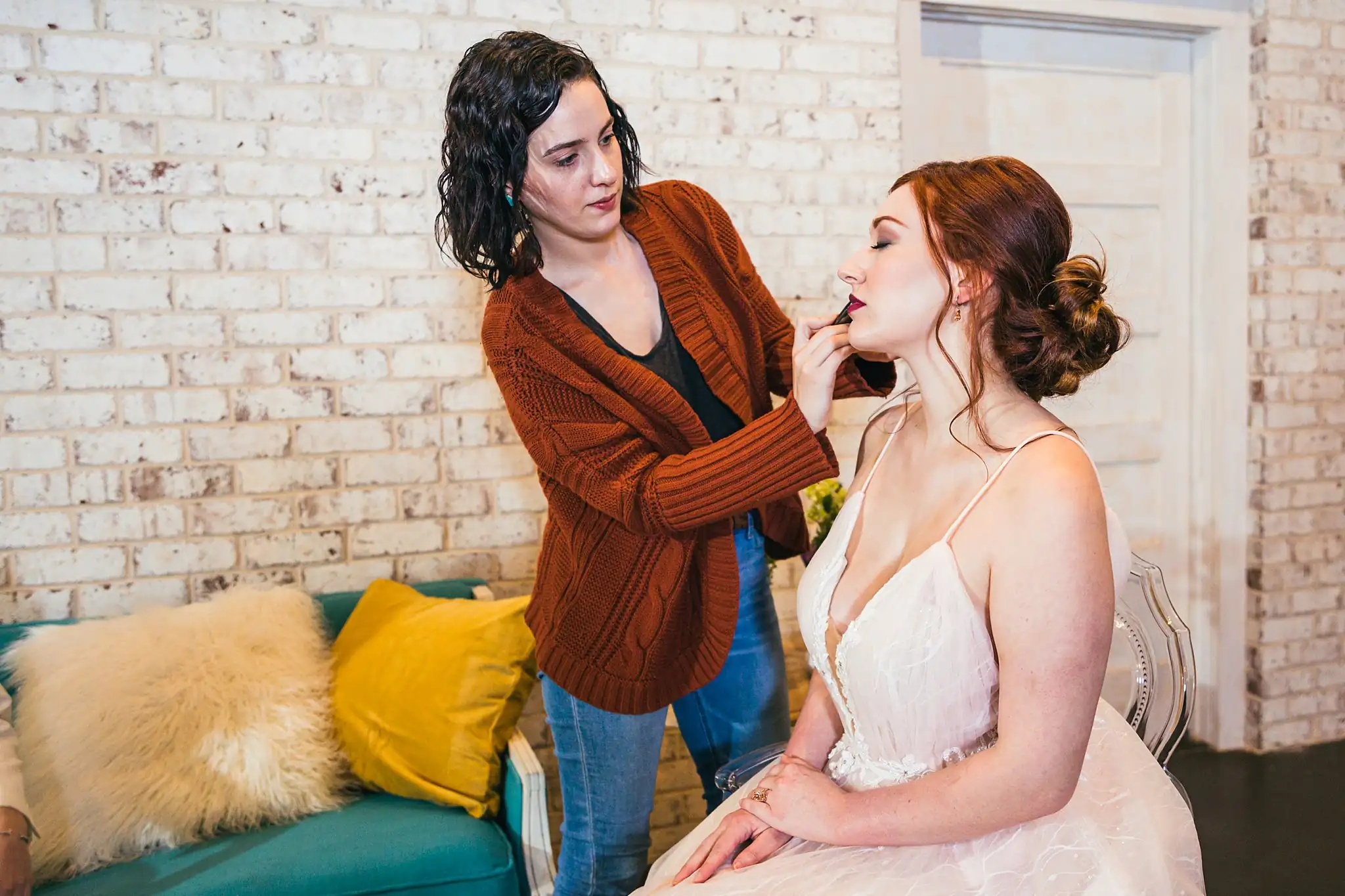 AtlantaWeddingPhotographers_1224.jpg Getting Ready: makeup being done on the bride in the gown, at a Whimsically in Love LGBTQ Wedding styled shoot at Brick and Ivey in Marietta, GA