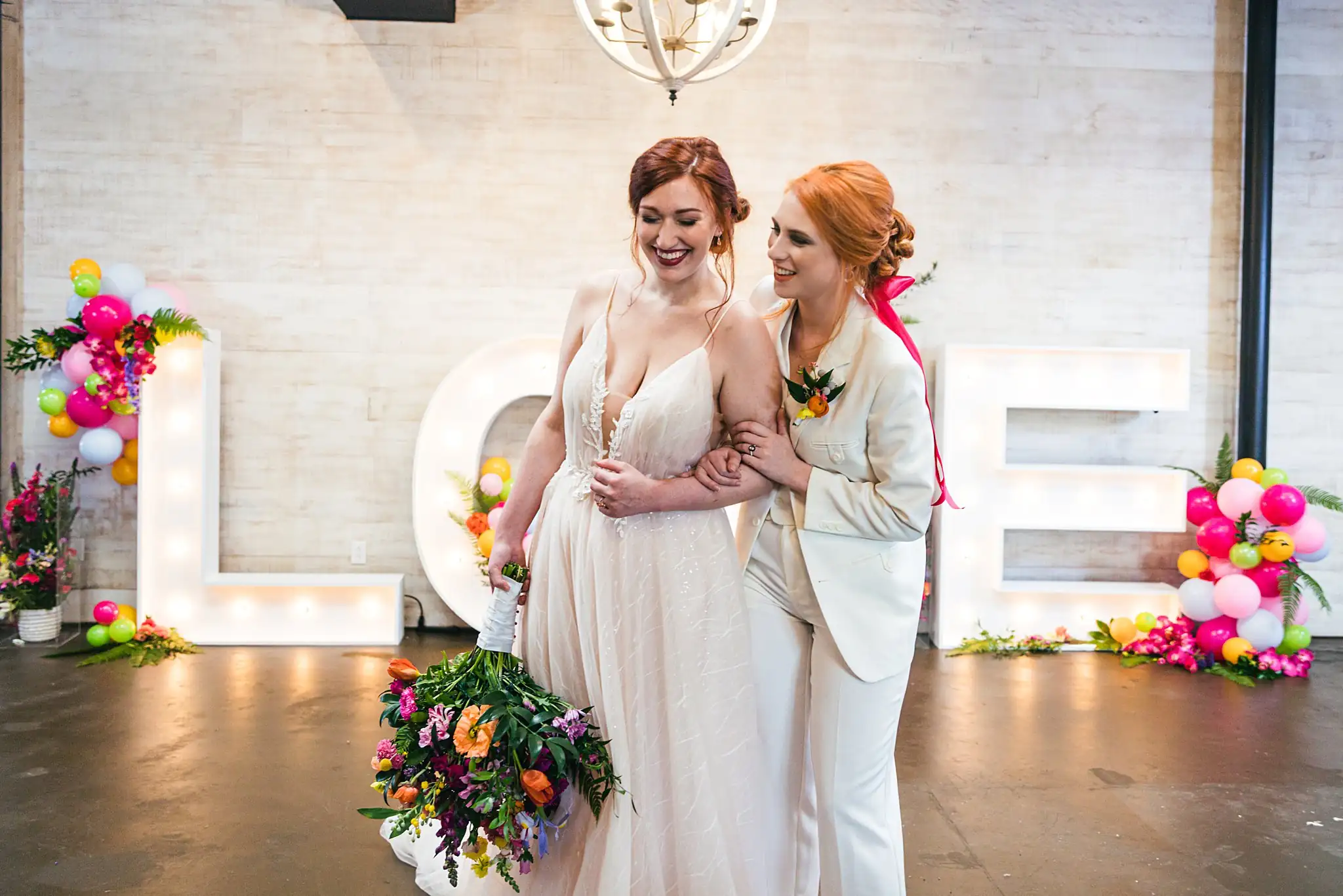 AtlantaWeddingPhotographers_1235.jpg Wedding Formals: the couple arm in arm with the bouquet, at a Whimsically in Love LGBTQ Wedding styled shoot at Brick and Ivey in Marietta, GA
