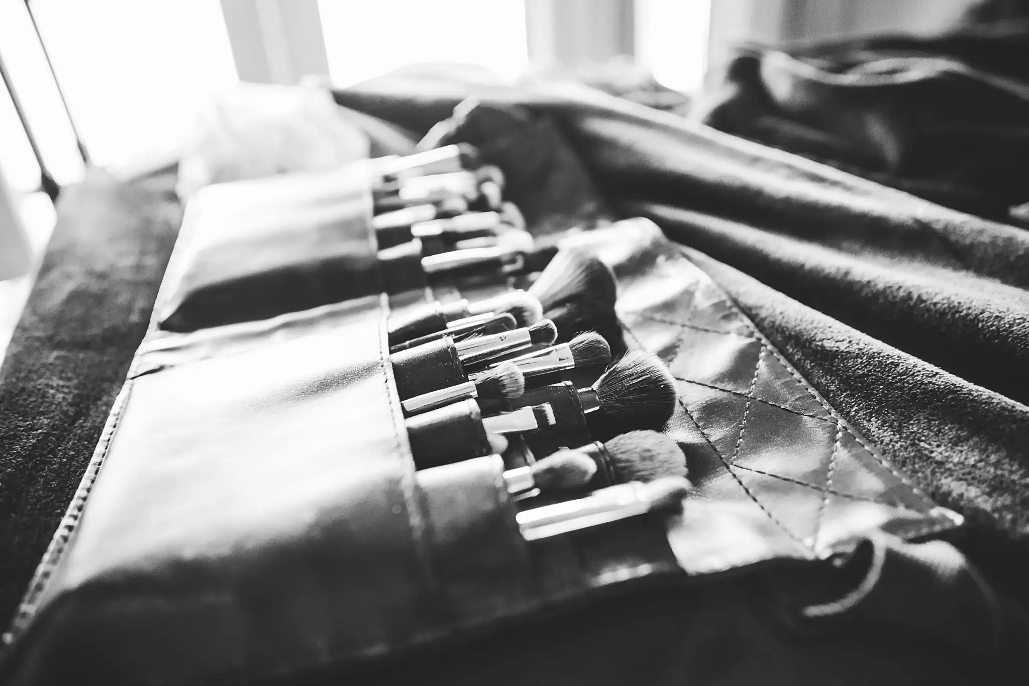 Getting Ready: makeup brushes laid out, in black and white, before their wedding at Ashton Gardens Atlanta in Sugar Hill, GA