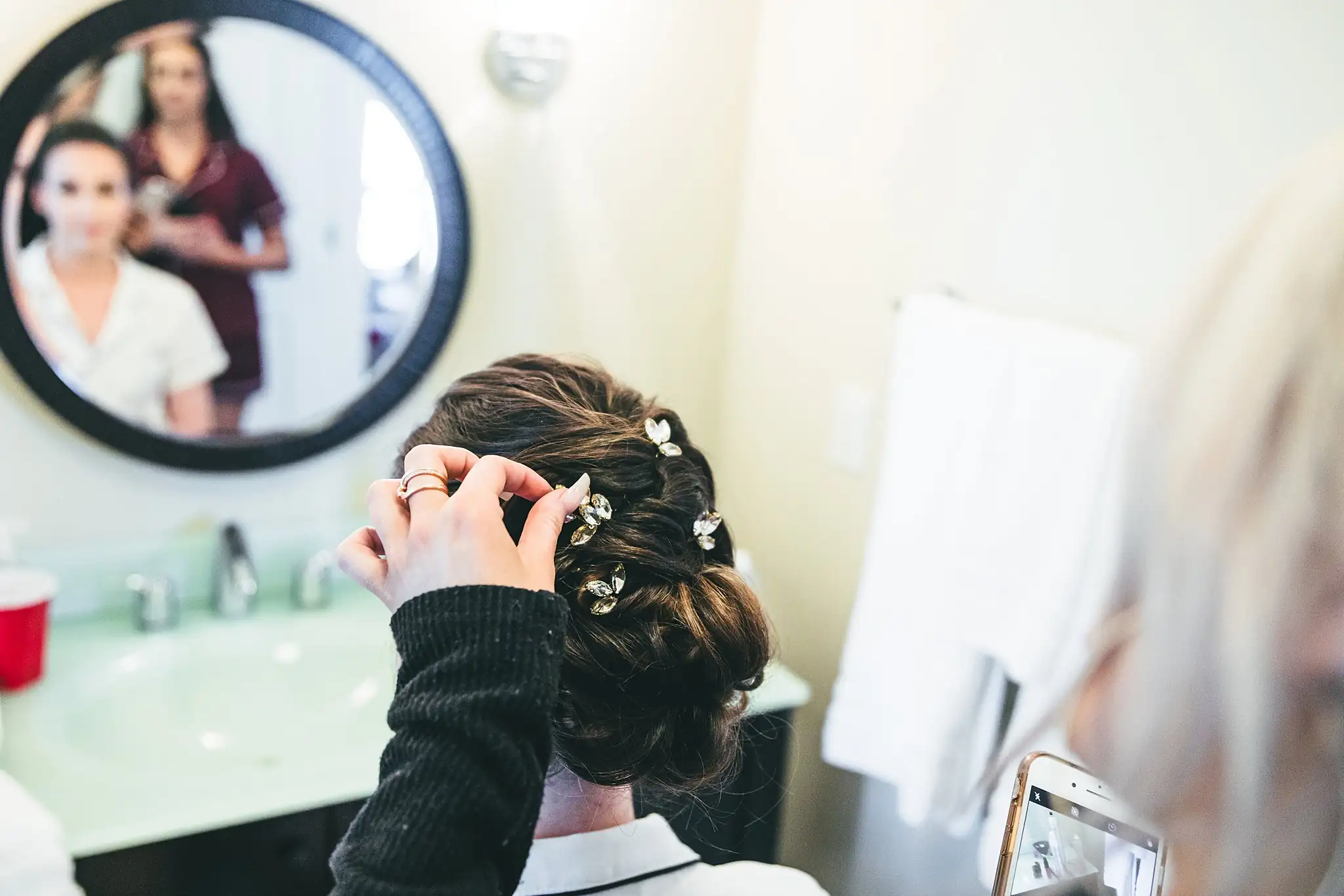 Getting Ready: hairpins being set into the bride's updo, before their wedding at Ashton Gardens Atlanta in Sugar Hill, GA