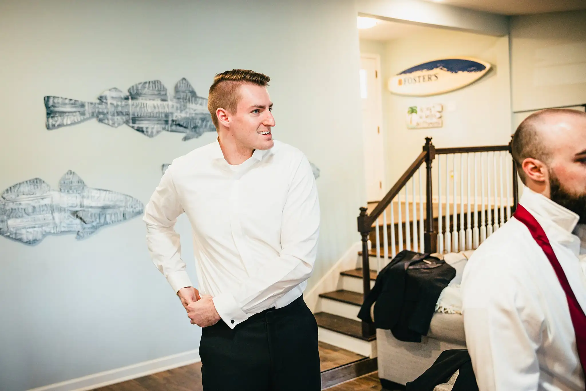 Getting Ready: the groom and a groomsman dressing, before their wedding at Ashton Gardens Atlanta in Sugar Hill, GA