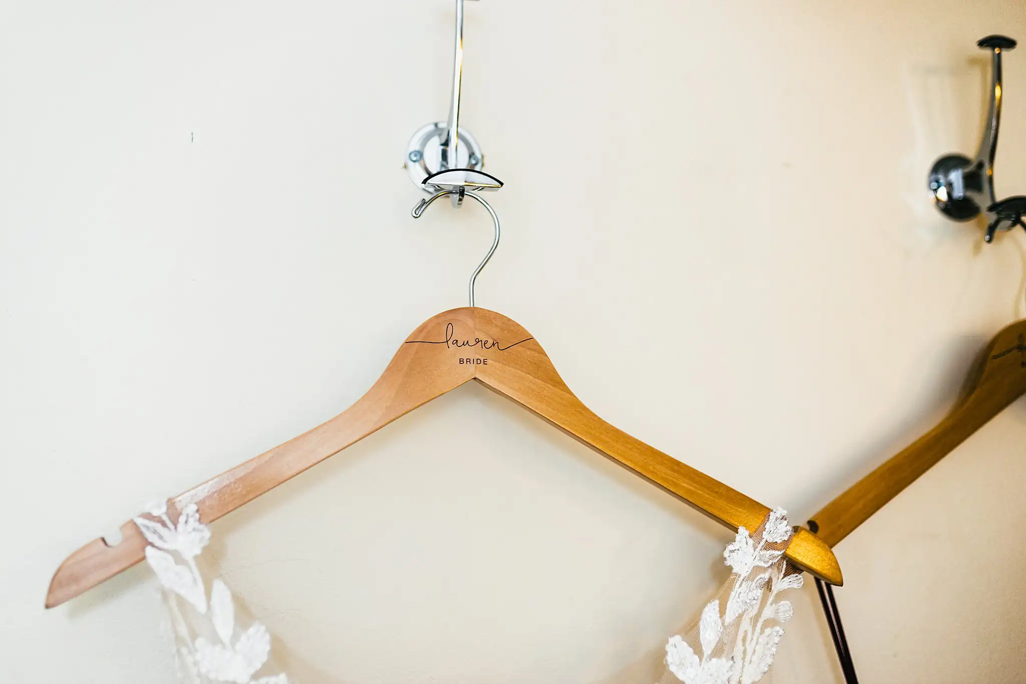 Wedding Details: the bride's empty hanger with its floral trim, at a wedding at Ashton Gardens Atlanta in Sugar Hill, GA