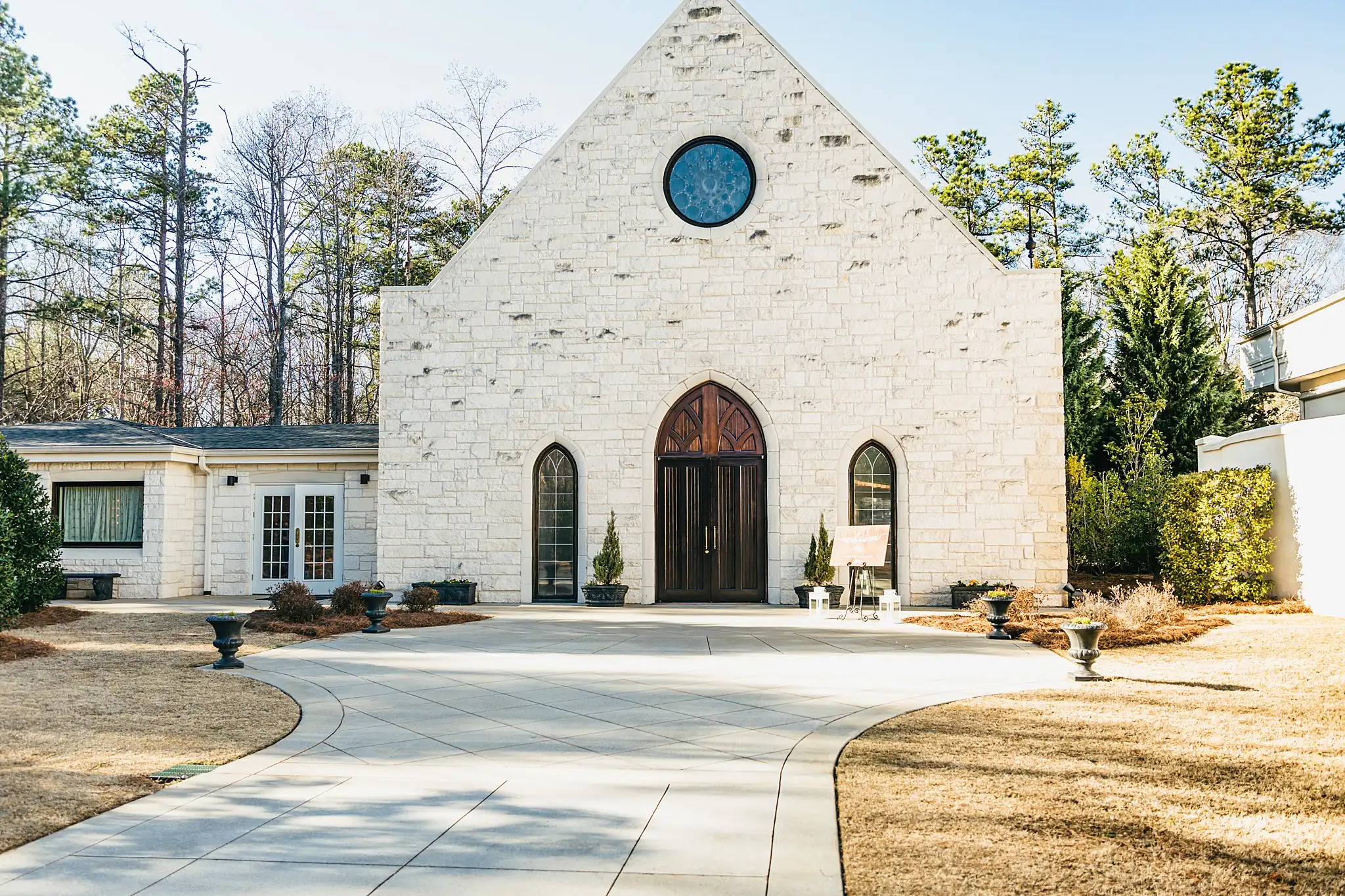 Wedding Ceremony: the stone chapel with its rose window, at a wedding at Ashton Gardens Atlanta in Sugar Hill, GA
