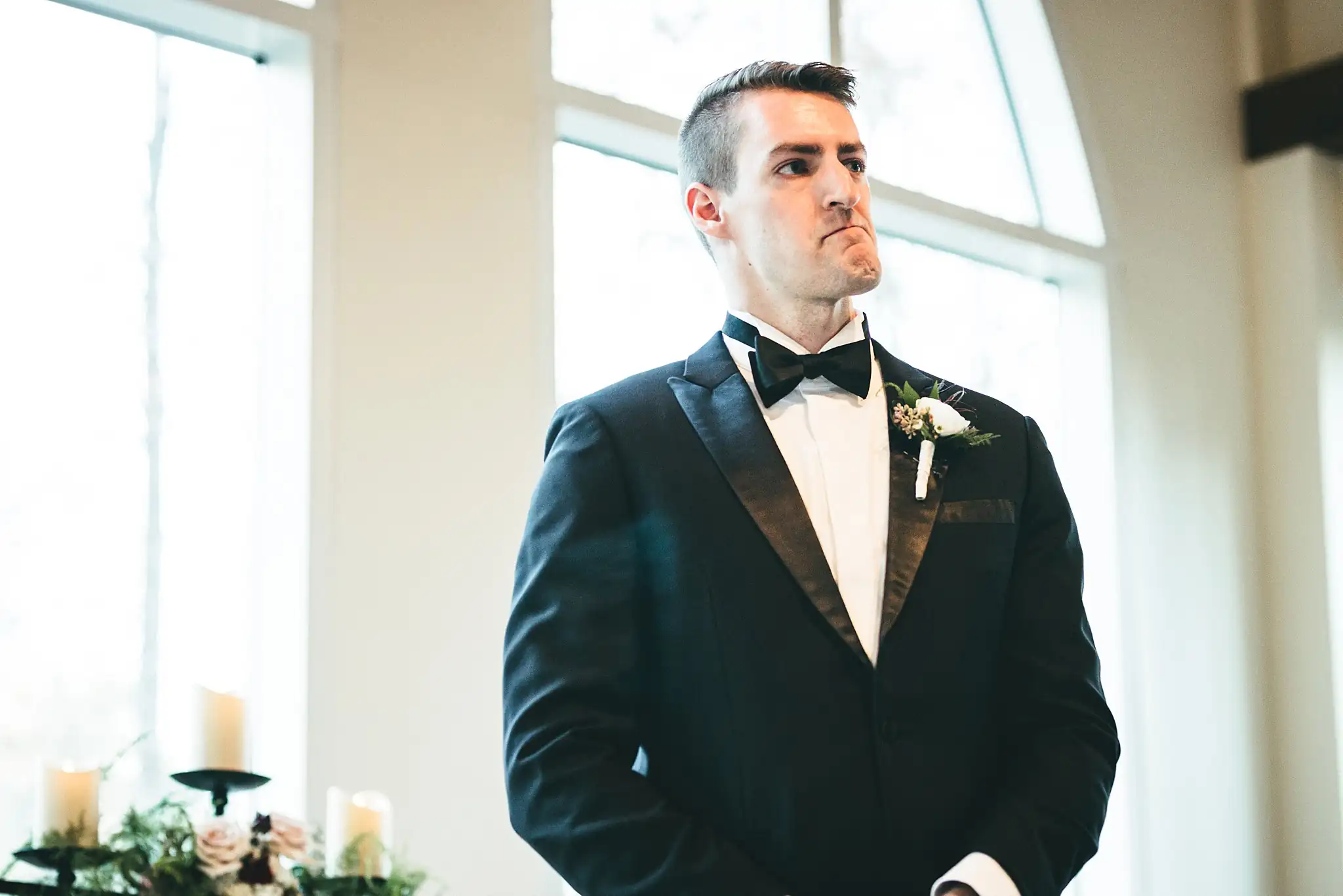 Wedding Ceremony: the groom waiting at the altar, close to tears, at their wedding at Ashton Gardens Atlanta in Sugar Hill, GA