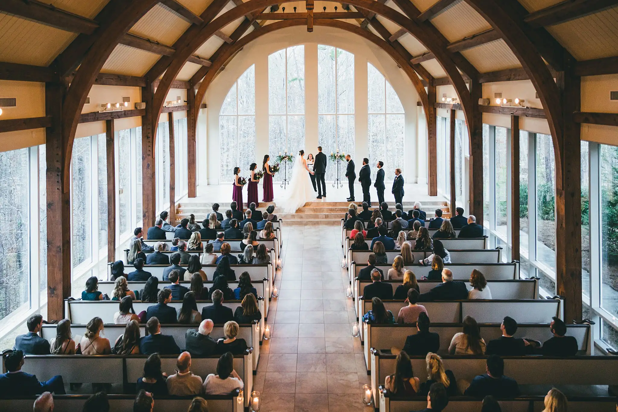 Wedding Ceremony: the full chapel seen from the back, at their wedding at Ashton Gardens Atlanta in Sugar Hill, GA