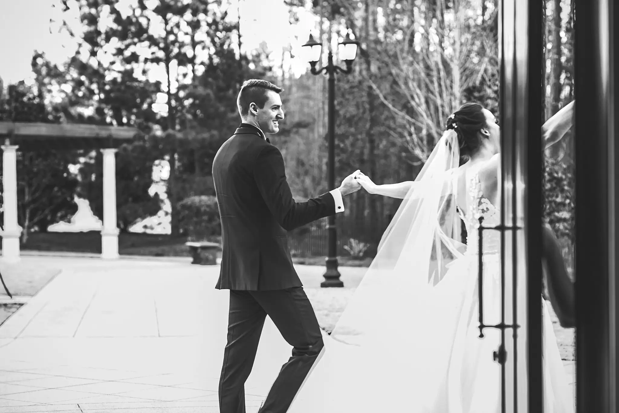 Recessional: the groom leading the bride by the hand, at their wedding at Ashton Gardens Atlanta in Sugar Hill, GA