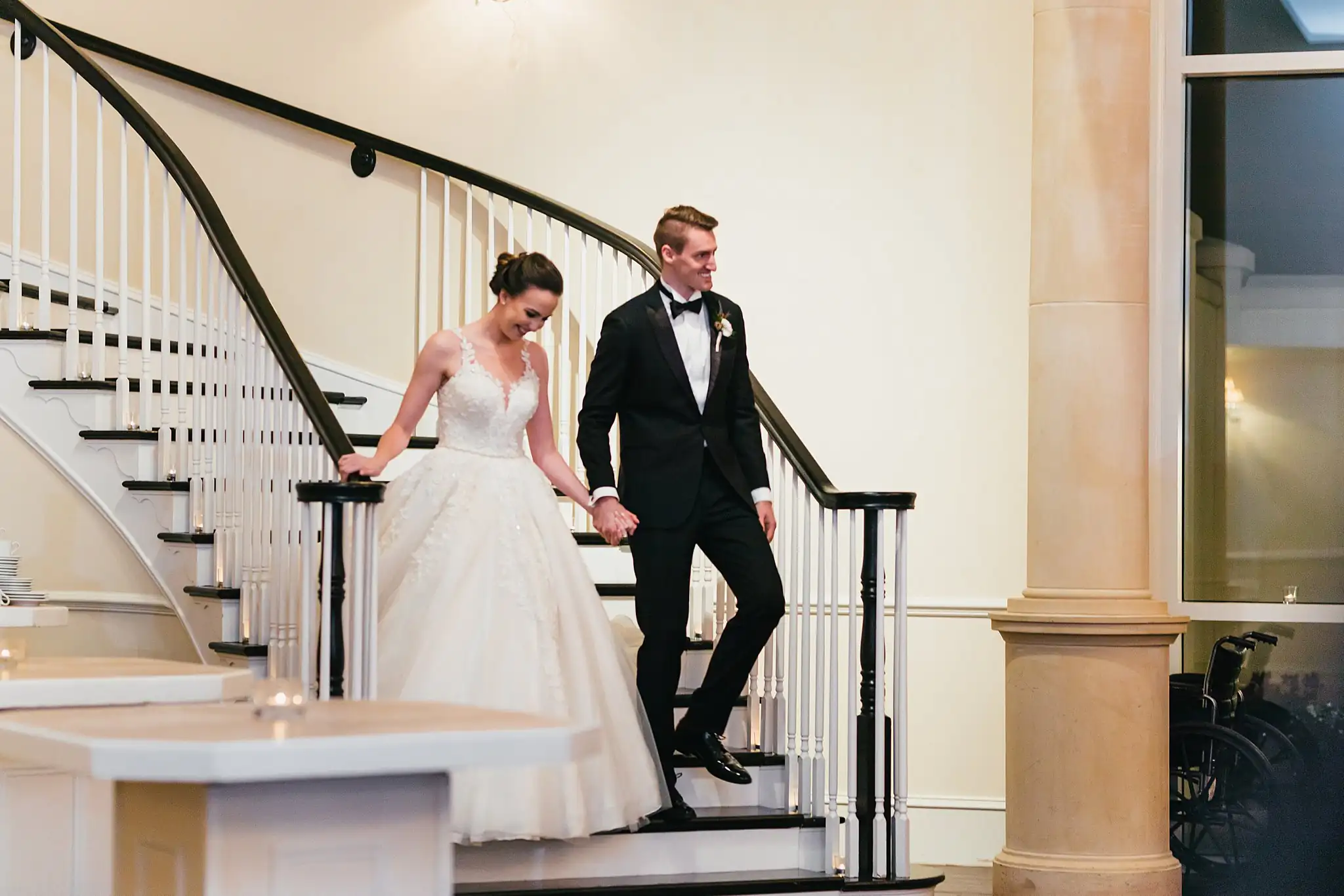Wedding Reception: the couple coming down the sweeping staircase, at their wedding at Ashton Gardens Atlanta in Sugar Hill, GA