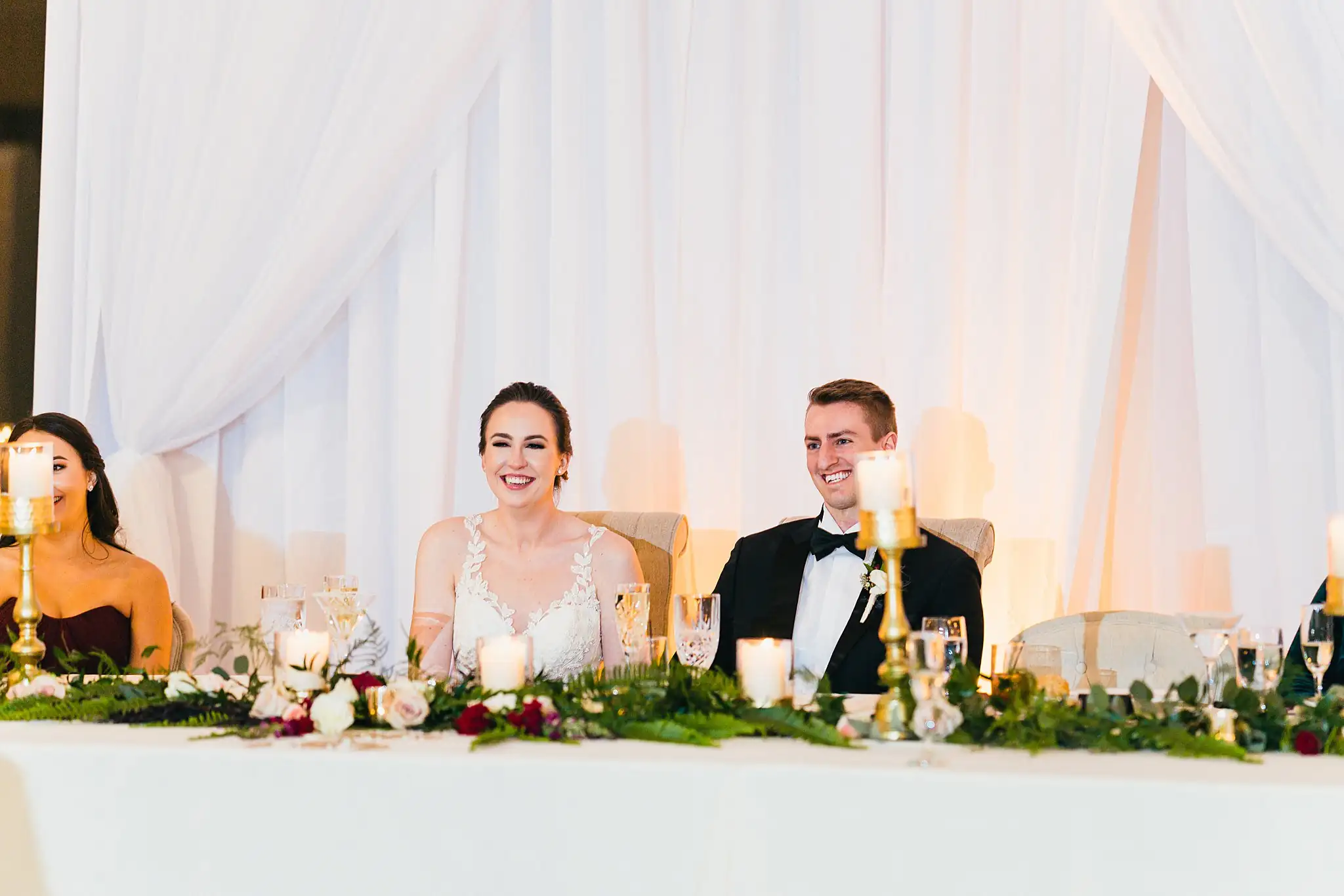 Wedding Reception: the couple listening from the head table, at their wedding at Ashton Gardens Atlanta in Sugar Hill, GA