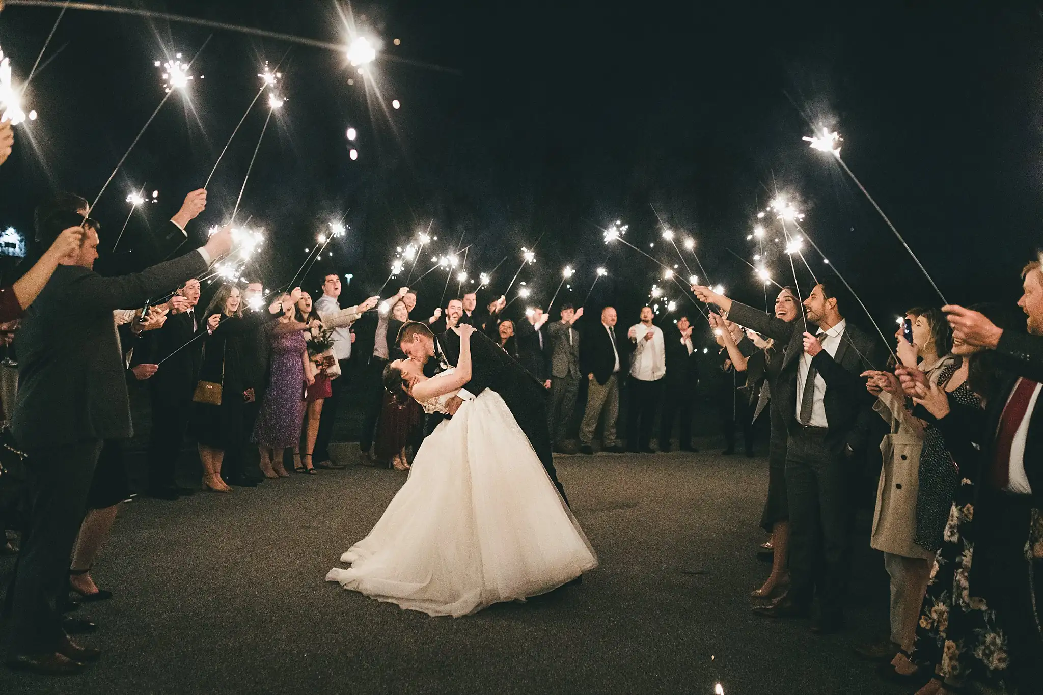 Sparkler Exit: the guests forming a tunnel of sparklers, at their wedding at Ashton Gardens Atlanta in Sugar Hill, GA