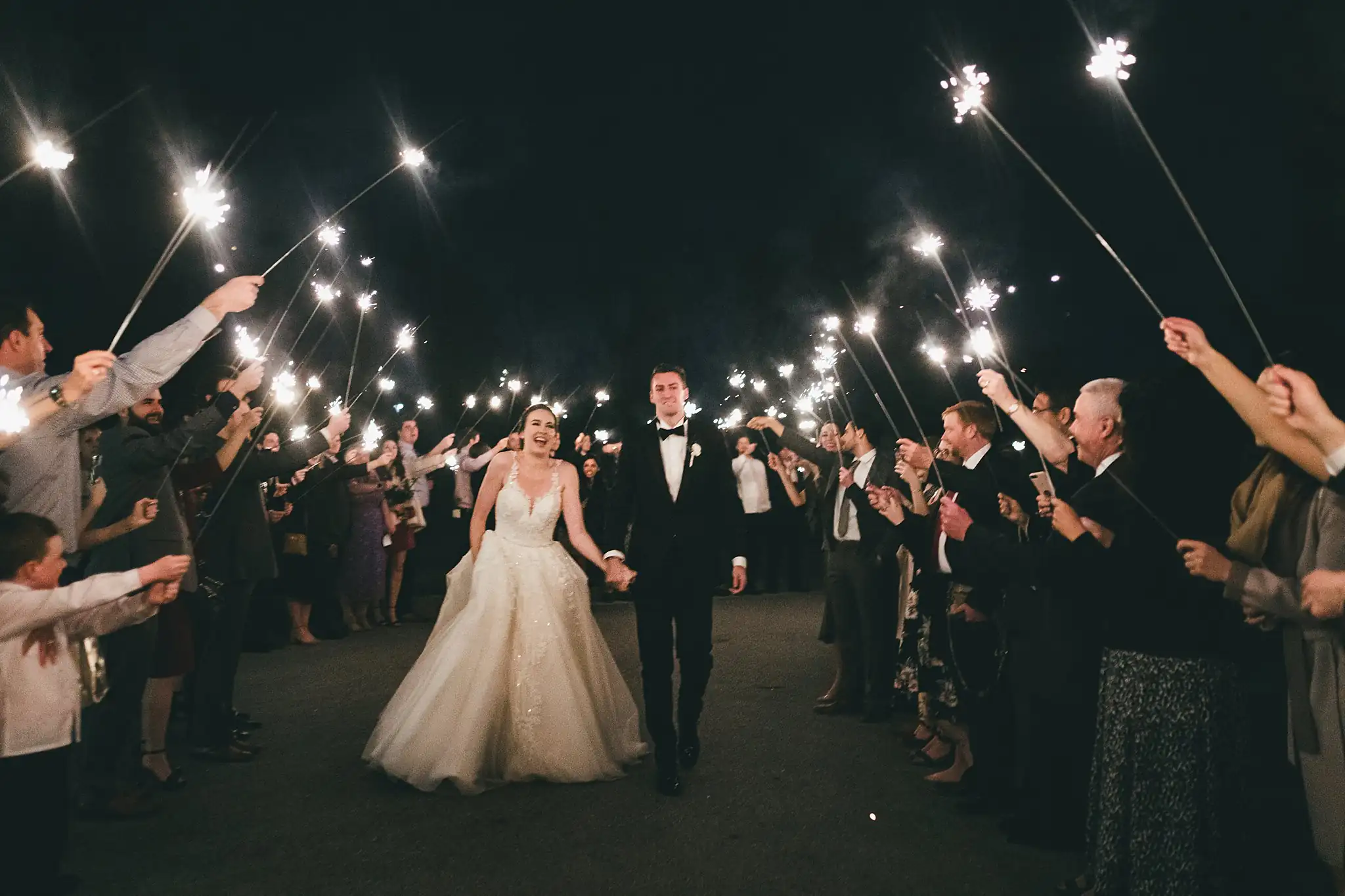 Sparkler Exit: the couple walking out through the sparklers, at their wedding at Ashton Gardens Atlanta in Sugar Hill, GA