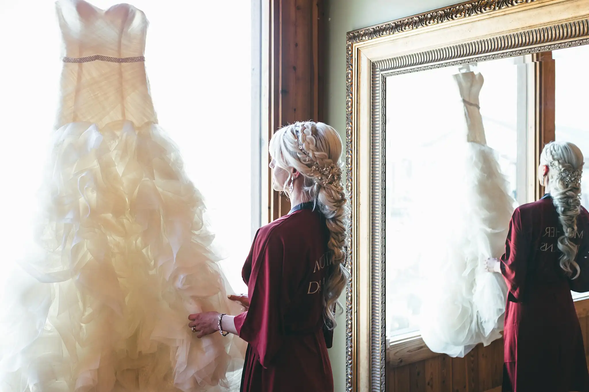 AtlantaWeddingPhotographers_1419.jpg Getting Ready: the bride looking at her ruffled gown, before their wedding at Three Birches in Alpharetta, GA