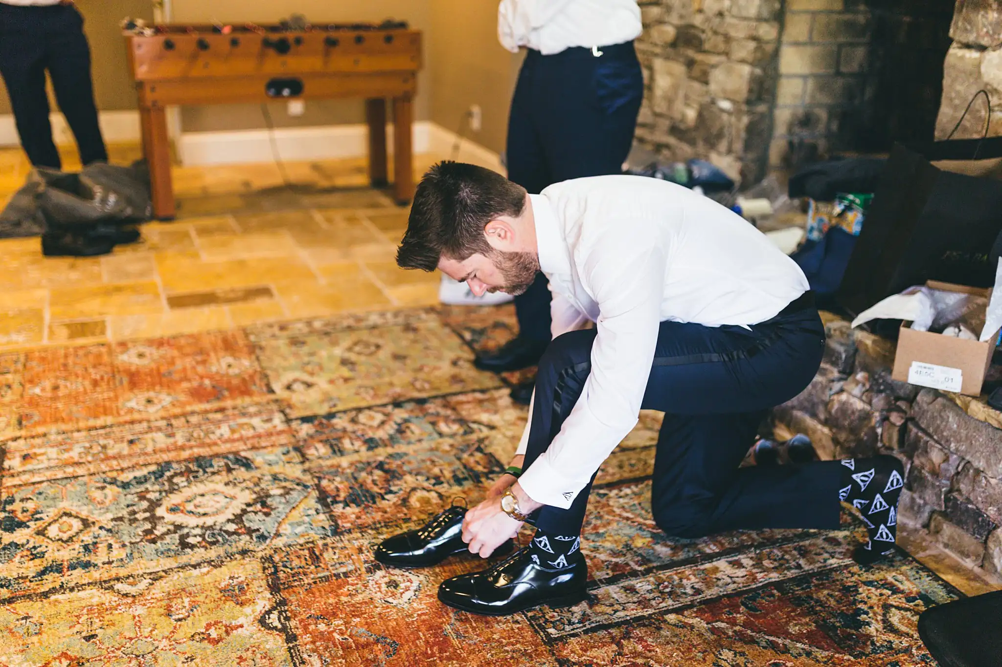 AtlantaWeddingPhotographers_1426.jpg Getting Ready: the groom tying his shoes, before their wedding at Three Birches in Alpharetta, GA