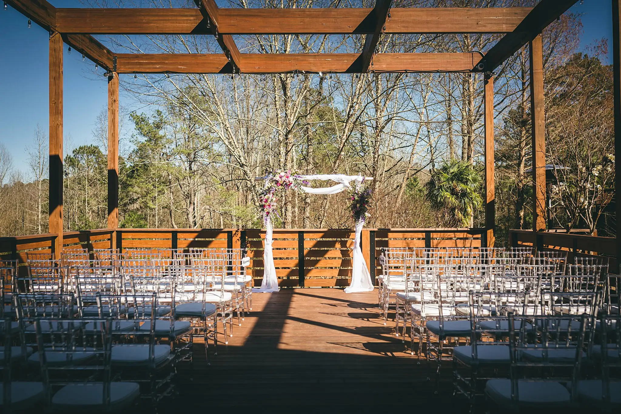 AtlantaWeddingPhotographers_1431.jpg Wedding Ceremony: the ceremony set under the timber pergola, at a wedding at Three Birches in Alpharetta, GA