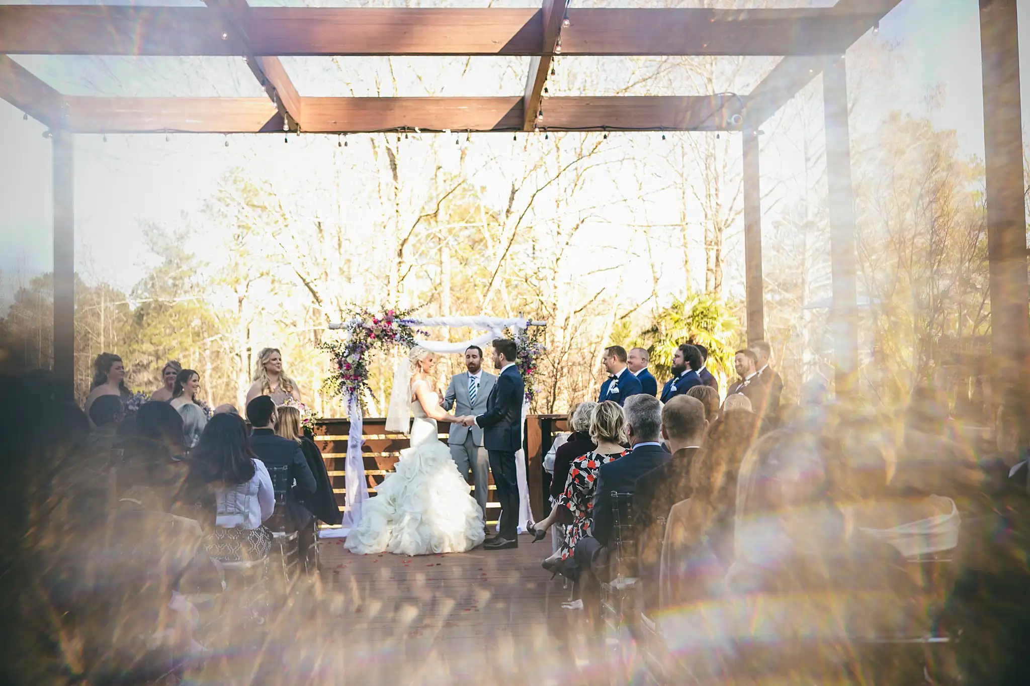 AtlantaWeddingPhotographers_1439.jpg Wedding Ceremony: the couple at the arch, seen through a prism, at their wedding at Three Birches in Alpharetta, GA