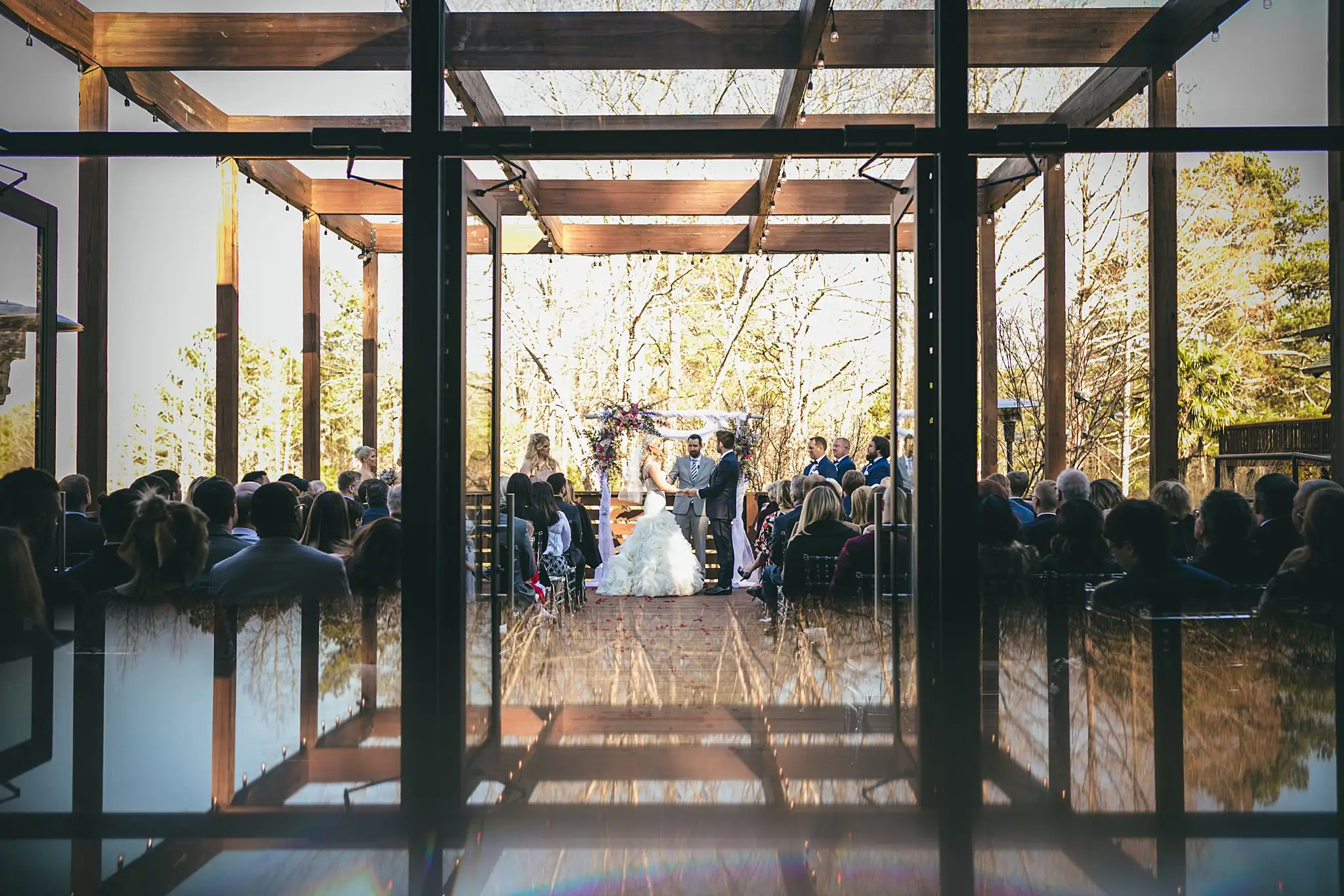 AtlantaWeddingPhotographers_1440.jpg Wedding Ceremony: the ceremony reflected in the glass walls, at their wedding at Three Birches in Alpharetta, GA