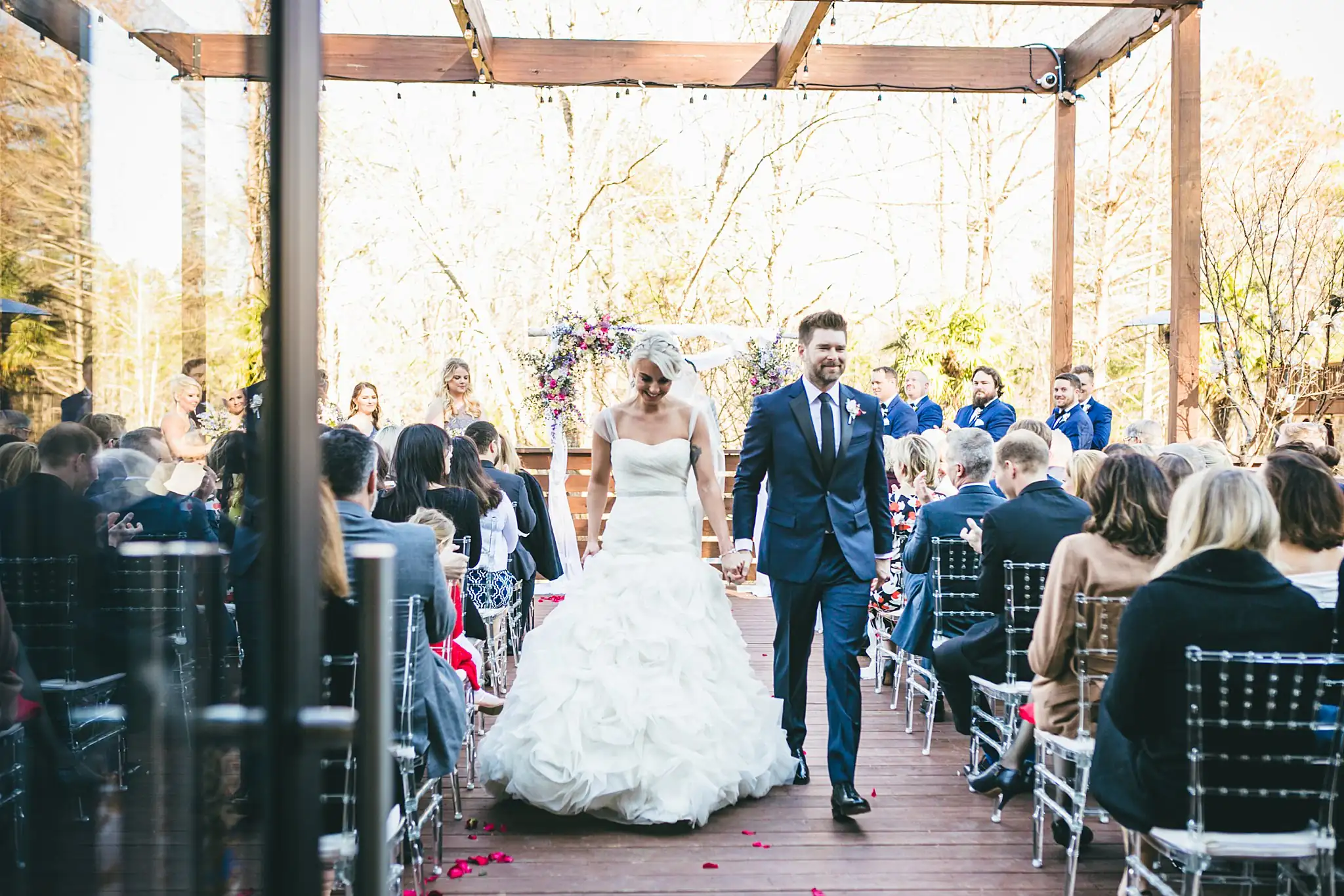 AtlantaWeddingPhotographers_1442.jpg Recessional: the couple walking out down the petal aisle, at their wedding at Three Birches in Alpharetta, GA