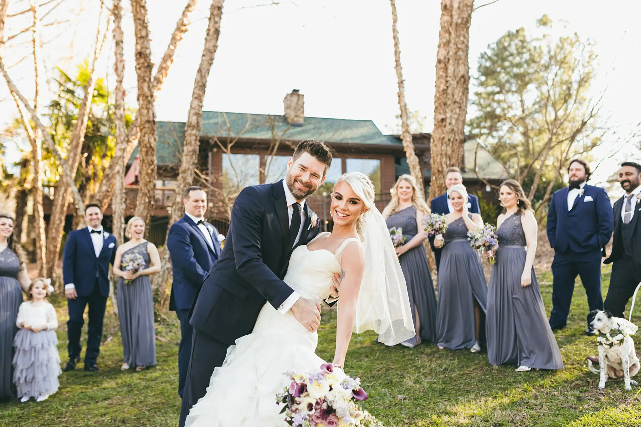 AtlantaWeddingPhotographers_1448.jpg Wedding Party: the groom dipping the bride as the party cheer, at their wedding at Three Birches in Alpharetta, GA