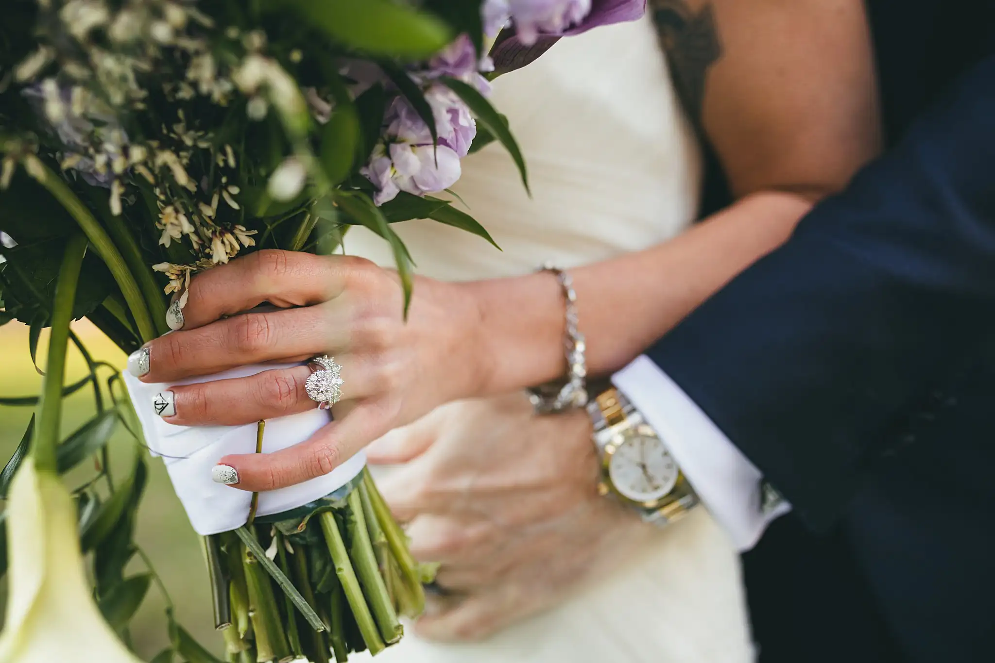 AtlantaWeddingPhotographers_1457.jpg Wedding Details: her ring on his shoulder above the bouquet, at a wedding at Three Birches in Alpharetta, GA