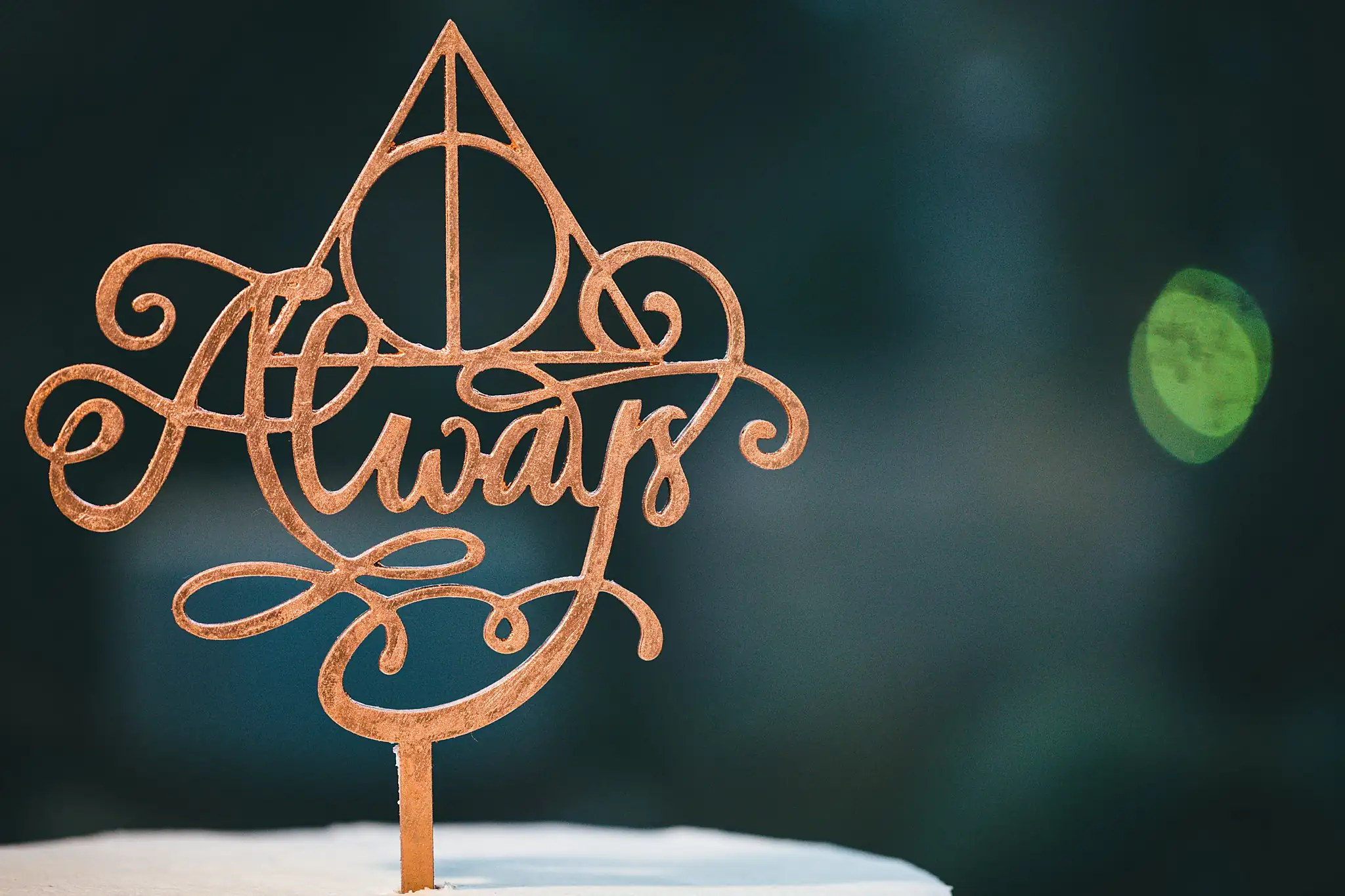 AtlantaWeddingPhotographers_1472.jpg Wedding Cake Details: the copper Always topper with the Deathly Hallows, at their wedding at Three Birches in Alpharetta, GA