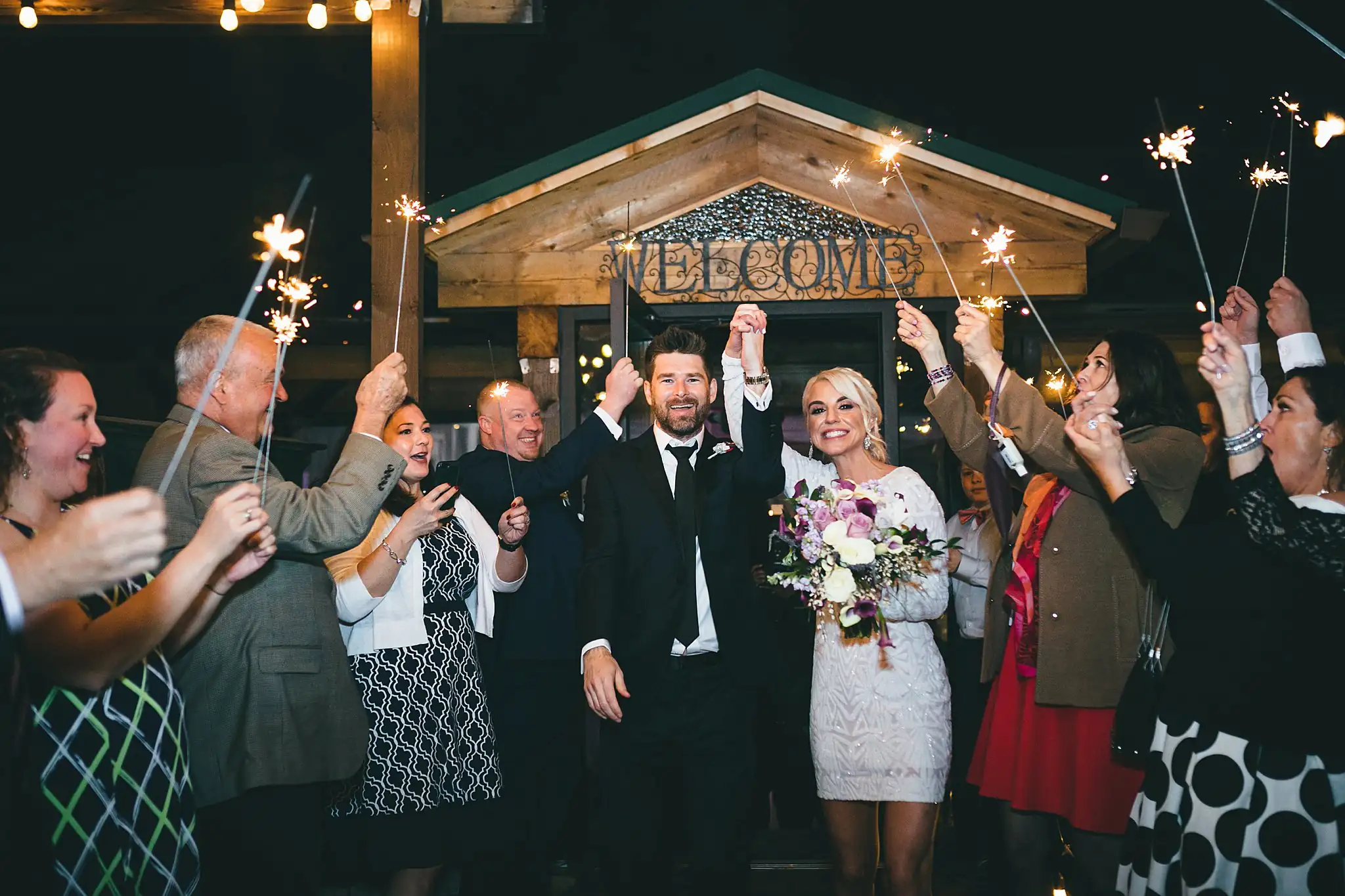 AtlantaWeddingPhotographers_1485.jpg Sparkler Exit: the sparklers lit beneath the welcome sign, at their wedding at Three Birches in Alpharetta, GA