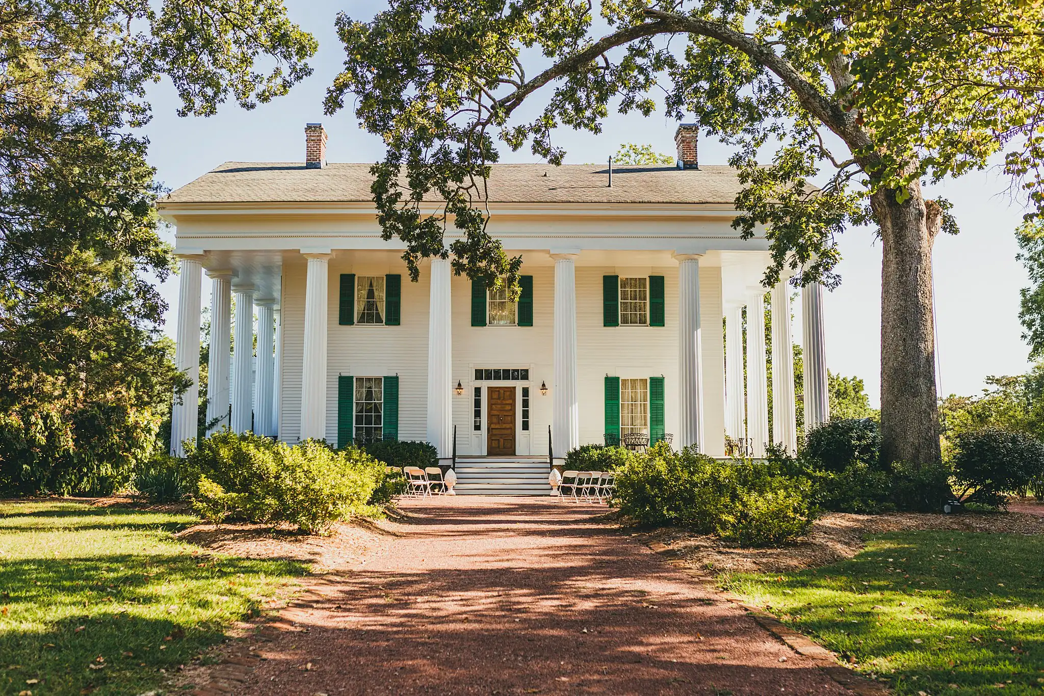 Wedding Ceremony: the house at the end of its tree-lined drive, at an intimate wedding at Barrington Hall in Roswell, GA