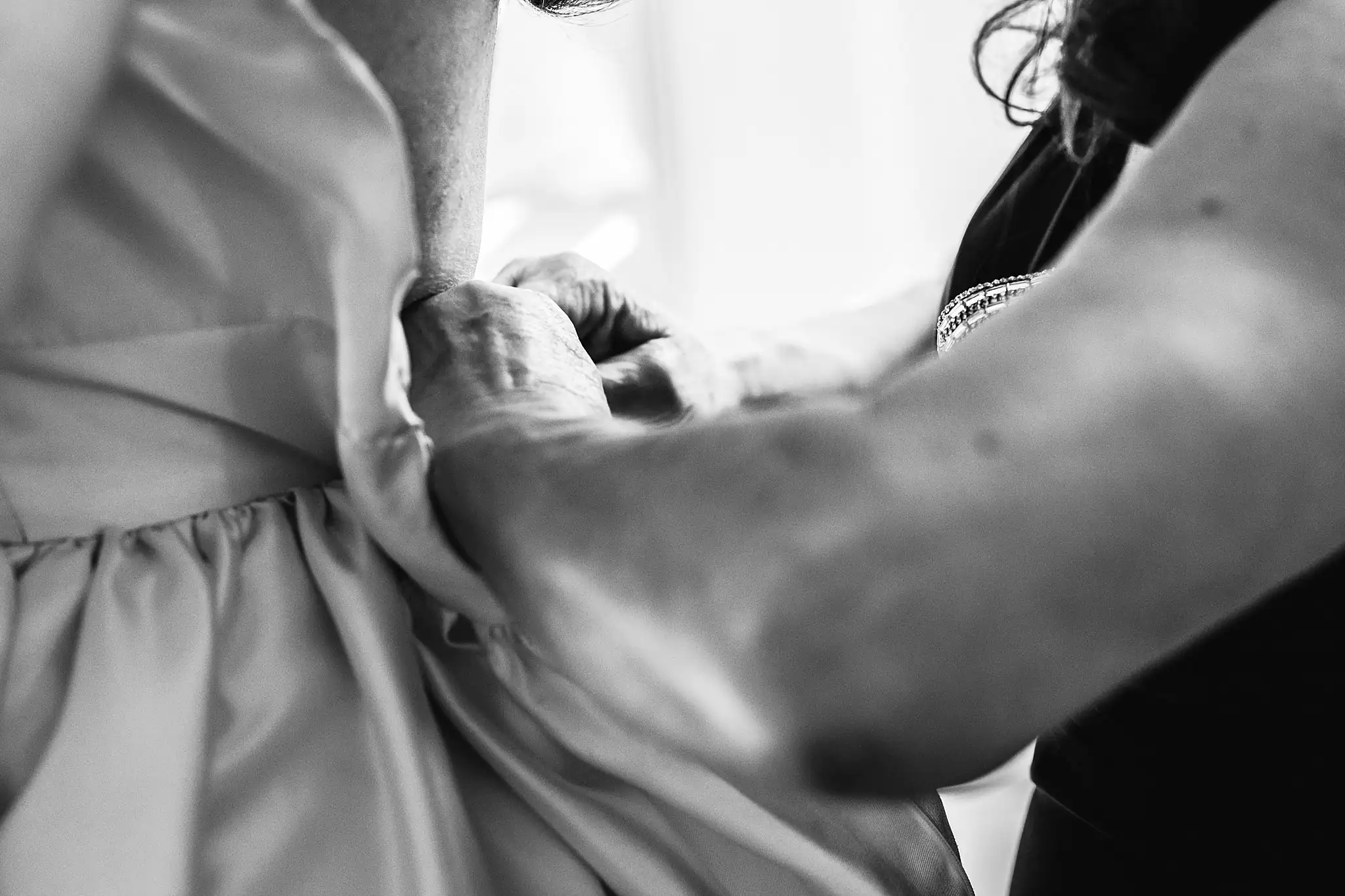 AtlantaWeddingPhotographers_1550.jpg Getting Ready: hands fastening the back of her gown, in black and white, before their tiny wedding at Barrington Hall in Roswell, GA