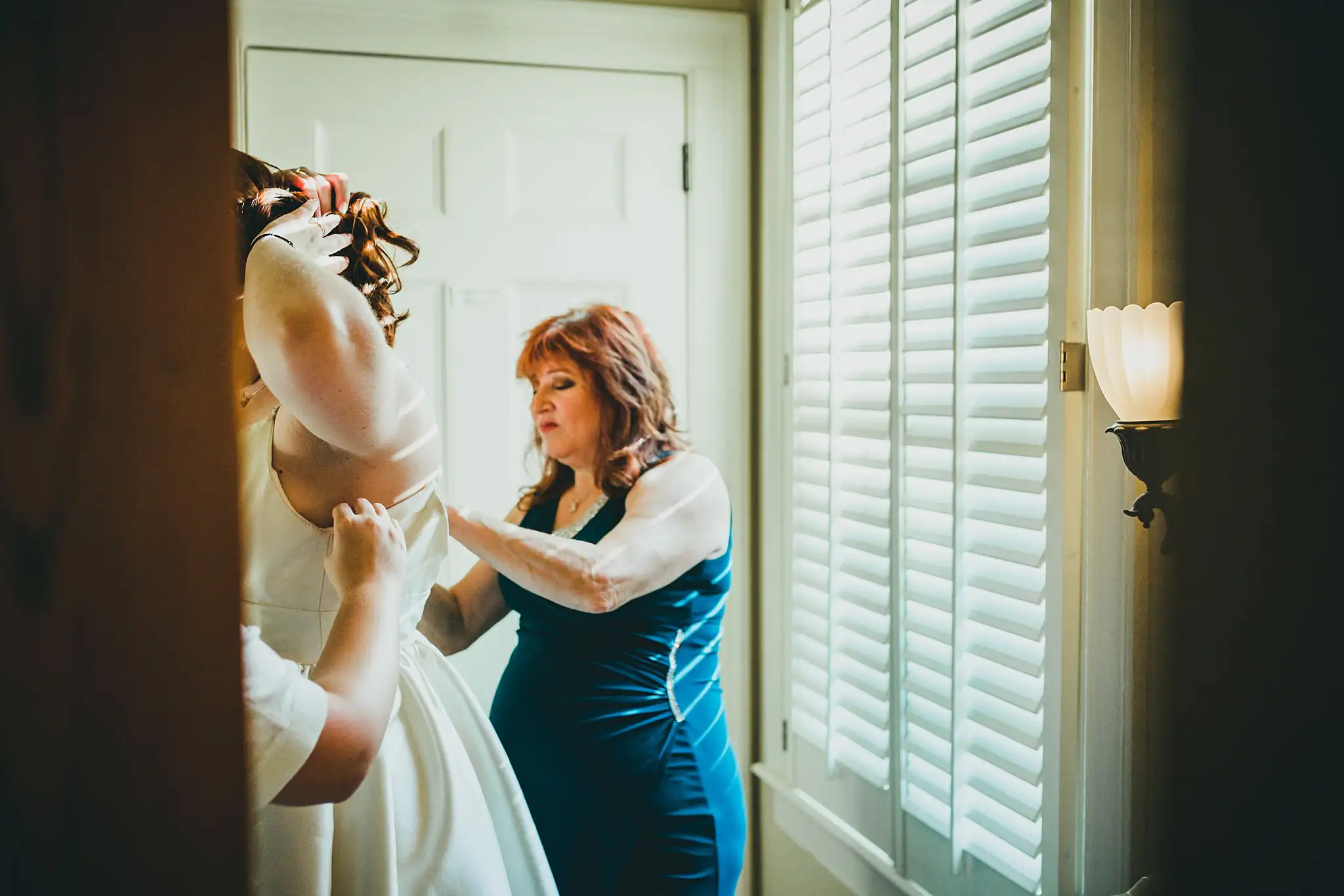 AtlantaWeddingPhotographers_1552.jpg Getting Ready: her veil being set in place at the window, before their intimate wedding at Barrington Hall in Roswell, GA