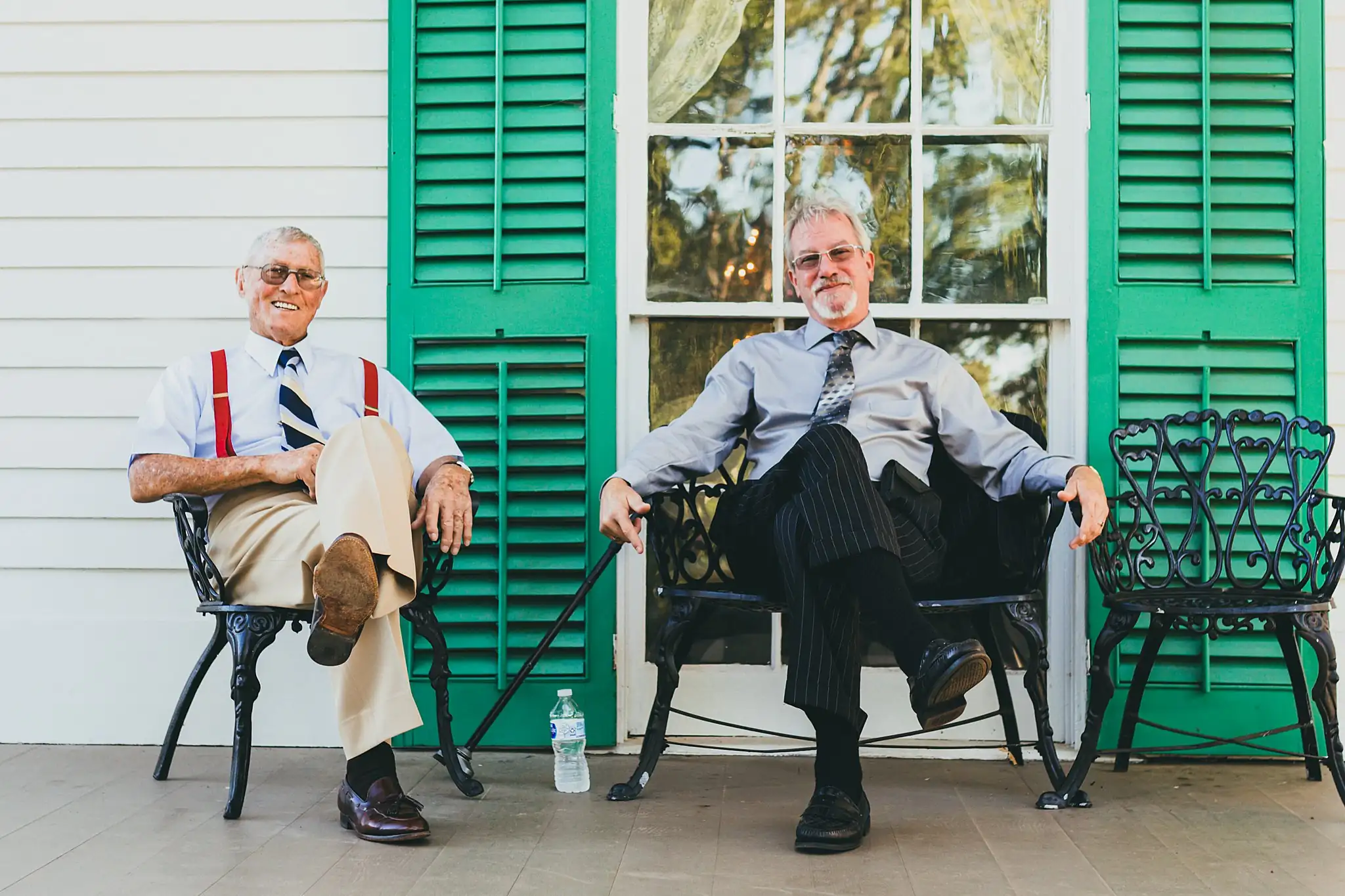 AtlantaWeddingPhotographers_1553.jpg Getting Ready: two guests waiting in chairs on the porch, before their tiny wedding at Barrington Hall in Roswell, GA