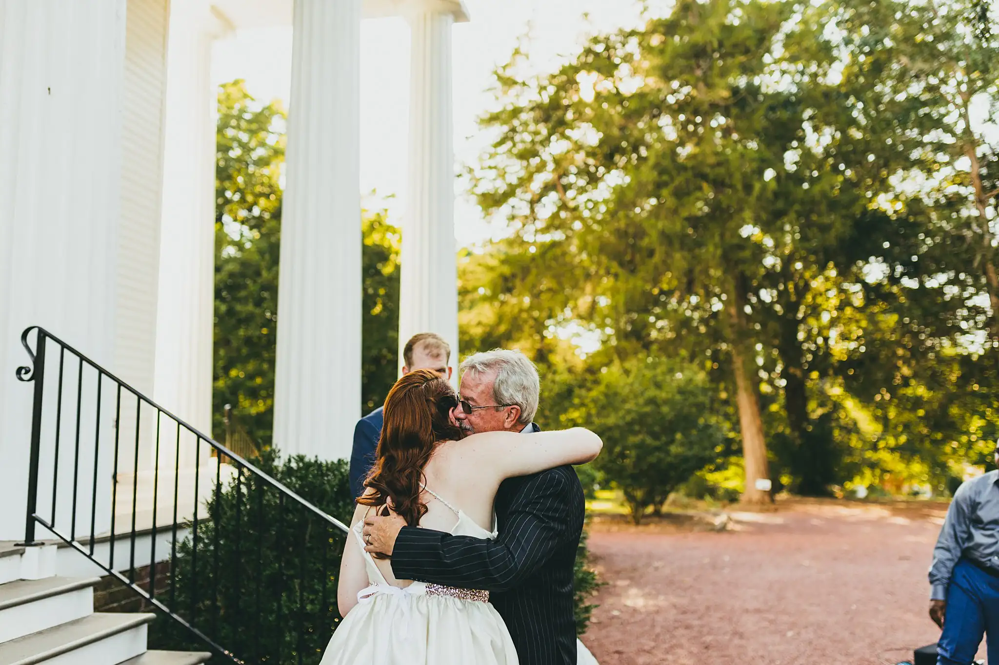 AtlantaWeddingPhotographers_1564.jpg Wedding Ceremony: the bride held tight by her father on the steps, at their micro ceremony at Barrington Hall in Roswell, GA