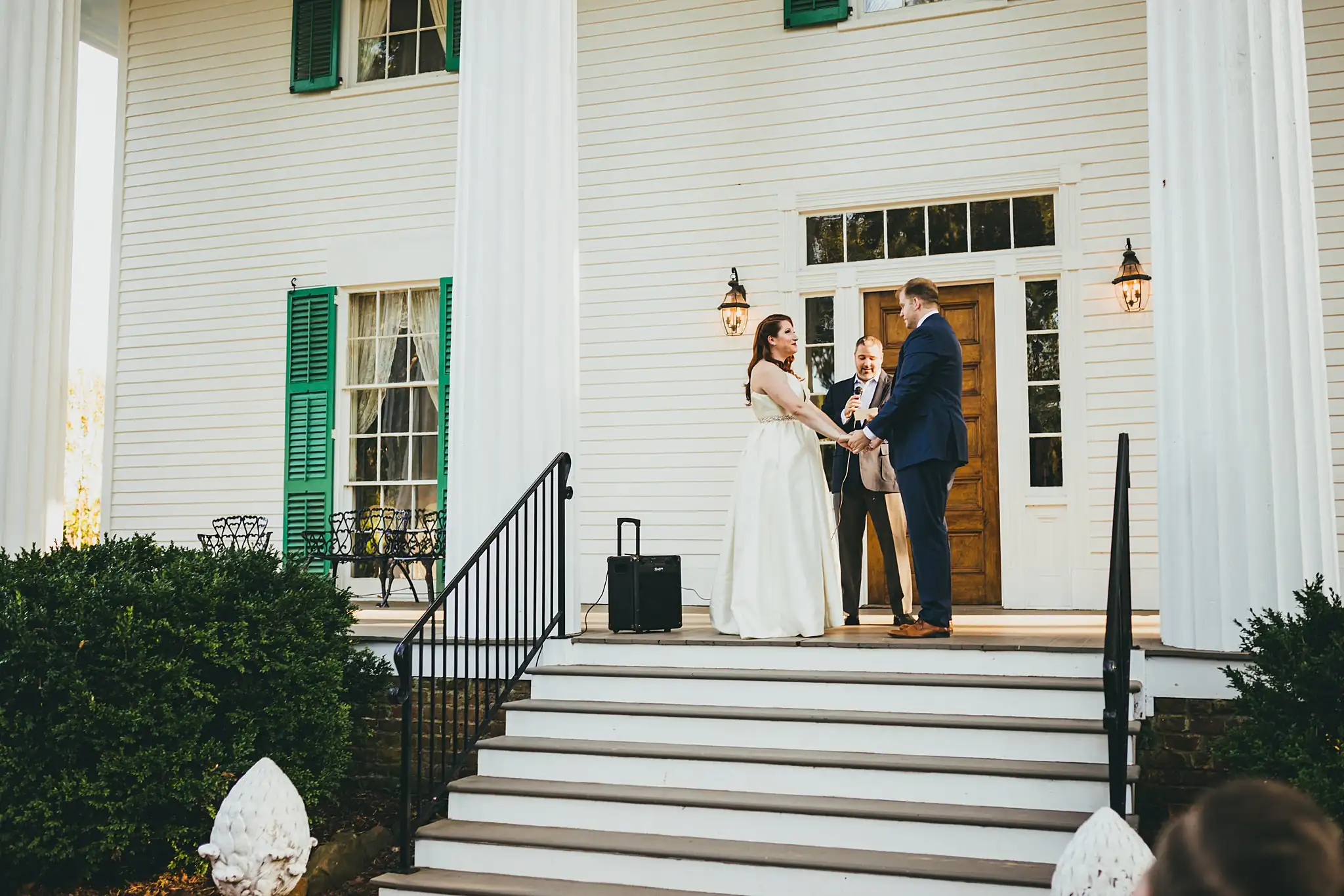 AtlantaWeddingPhotographers_1566.jpg Wedding Ceremony: the couple before the officiant at the top of the steps, at their micro ceremony at Barrington Hall in Roswell, GA