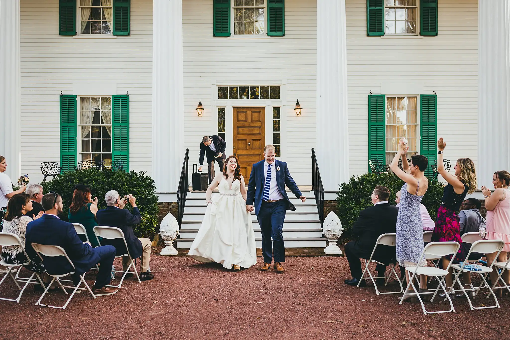 AtlantaWeddingPhotographers_1569.jpg Recessional: the couple coming down the steps past the guests, at their micro ceremony at Barrington Hall in Roswell, GA