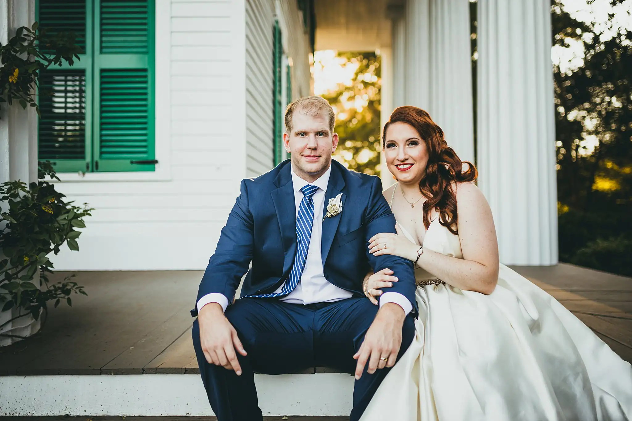 AtlantaWeddingPhotographers_1574.jpg Wedding Formals: the couple seated together on the portico step, at their micro wedding at Barrington Hall in Roswell, GA