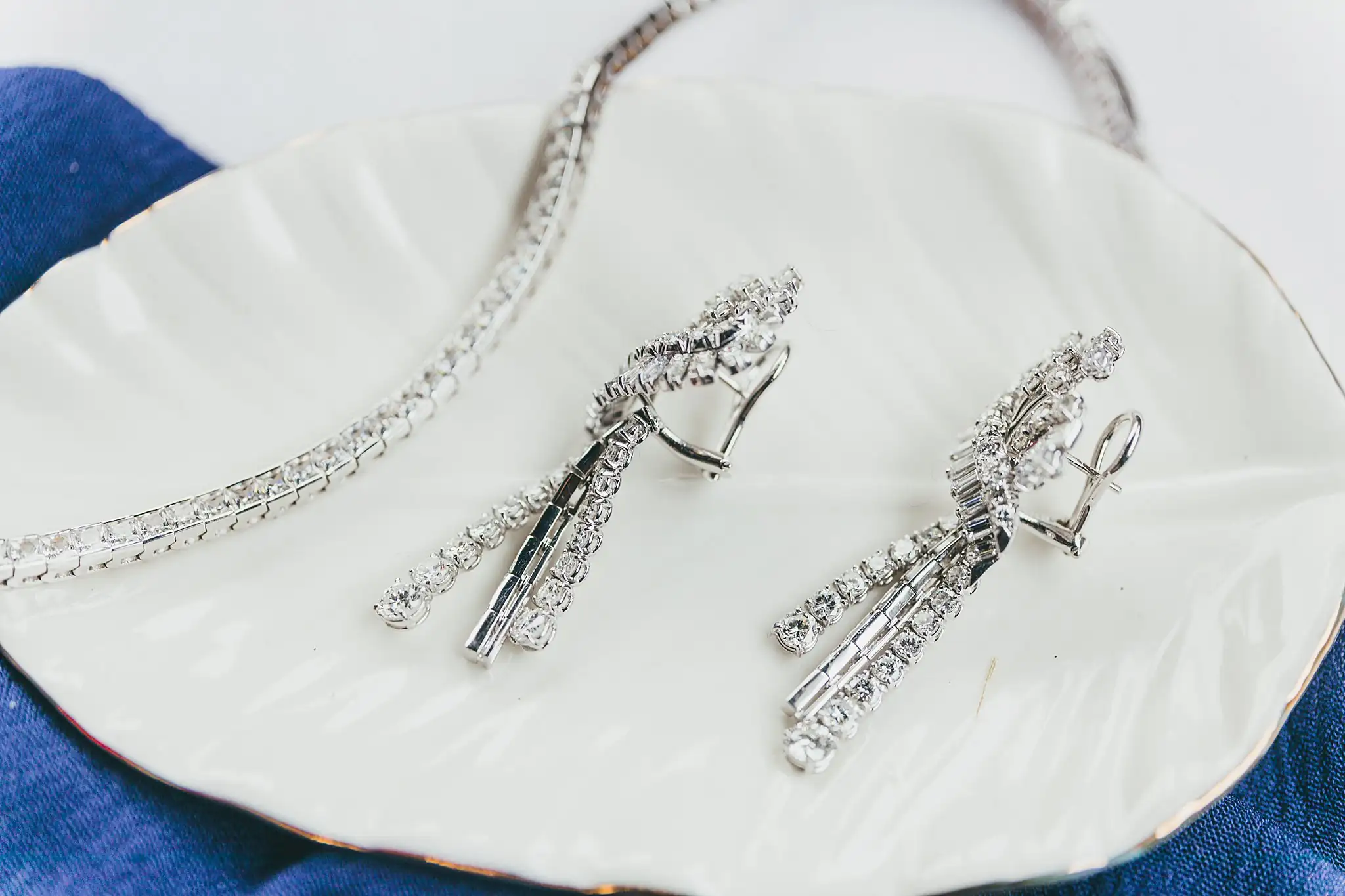 Styled Shoot Hollywood Regency Wedding Inspiration Atlanta Photographers Wedding Details: a crystal bracelet and earrings on a leaf dish, at a Hollywood Regency Wedding styled shoot at the Foxglove in Marietta, GA