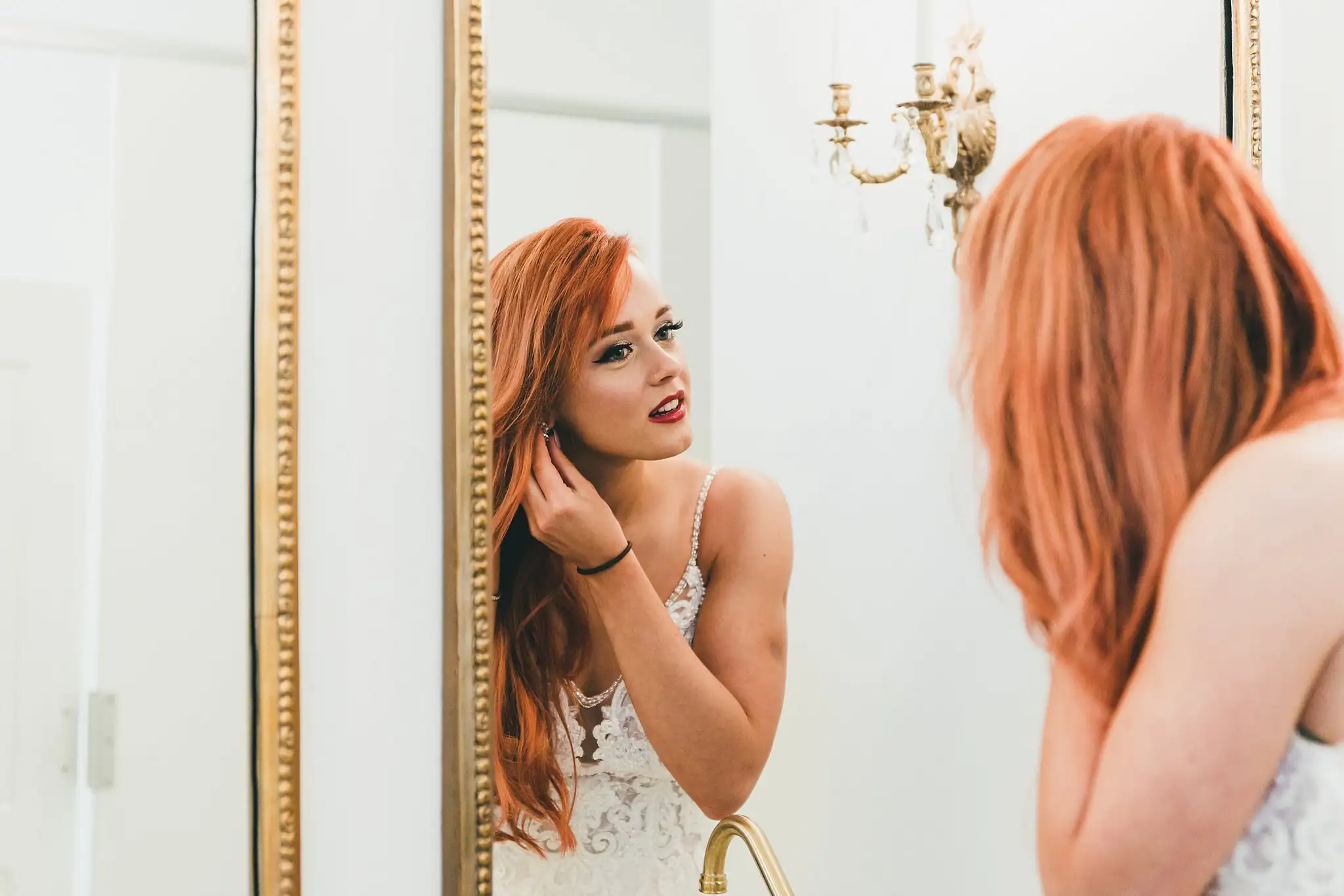 Styled Shoot Hollywood Regency Wedding Inspiration Atlanta Photographers Bridal Portraits: the bride in her beaded gown at a gold mirror, at a Hollywood Regency Wedding styled shoot at the Foxglove in Marietta, GA