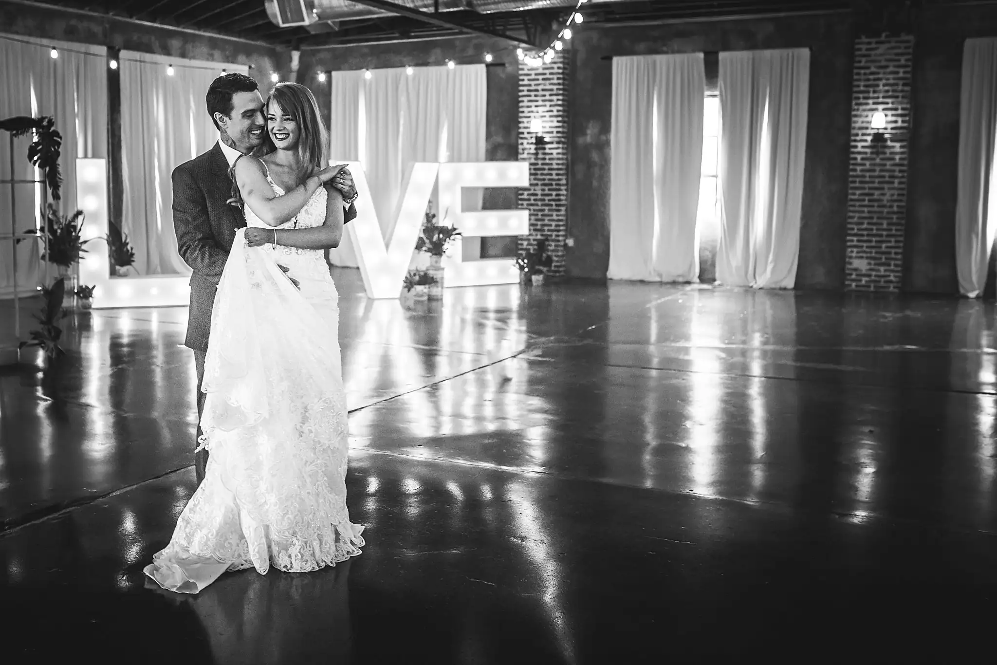 Styled Shoot Hollywood Regency Wedding Inspiration Atlanta Photographers First Dance: the couple dancing by the lit LOVE letters, at a Hollywood Regency Wedding styled shoot at the Foxglove in Marietta, GA