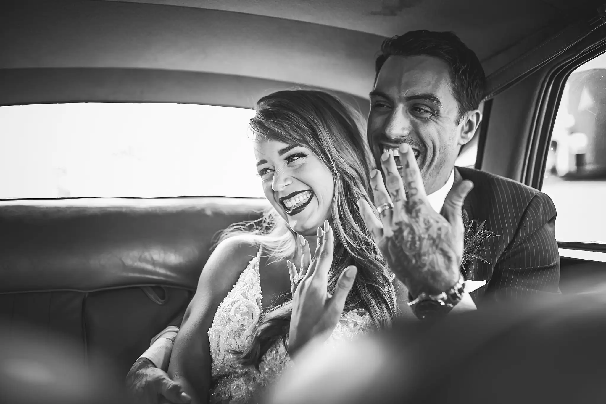 Styled Shoot Hollywood Regency Wedding Inspiration Atlanta Photographers Wedding Formals: the couple laughing in the car, in black and white, at a Hollywood Regency Wedding styled shoot at the Foxglove in Marietta, GA